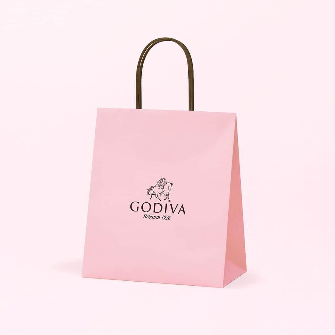 GODIVAさんのインスタグラム写真 - (GODIVAInstagram)「～幸せをお届けする華やかなさくら色の限定ショッピングバッグ～ 「さくらショッパー」が登場🌸 . ピンク色は、ロマンティックなシーズンや春の訪れを告げるアイコニックな色であり、ゴディバにとっても、その歴史の中で幸せを届ける象徴として、大切にしているカラーです。 . 第二次世界大戦後、敗戦の悲しみの中にあったブリュッセル市民を勇気づけようと、ゴディバのショコラティエのピエール・ドラップスは、配達用のバンをピンクに塗装し、チョコレートを恵まれない人々に届けました。暗く沈んだ街でこの可愛らしいバンを見かけた市民は、ピエールの想いに心を打たれ、復興への希望を見出したと言われています。 . ゴディバは、この想いを受け継ぎ、幸せの色に彩られた特別なショッピングバッグ「さくらショッパー」を限定販売いたします。 . 「おめでとう」「ありがとう」「元気でね」。大切な方への贈り物や春の手土産に、 お祝いや感謝の気持ちを伝えるギフトを包む、 「さくらショッパー」で優しい彩りを添えてみませんか。 . 全国の有名百貨店内ゴディバショップ、ゴディバ専門店及びゴディバ オンラインショップにて販売中です。 . ※店舗により取扱期間が異なります。 ※各店舗無くなり次第終了いたします。 . #ゴディバ #チョコレート #チョコ #ショッパー #さくら #桜 #ギフト #プレゼント #お祝い  #godiva #chocolate #sakura #shipping #gift #present」3月25日 12時00分 - godiva_japan