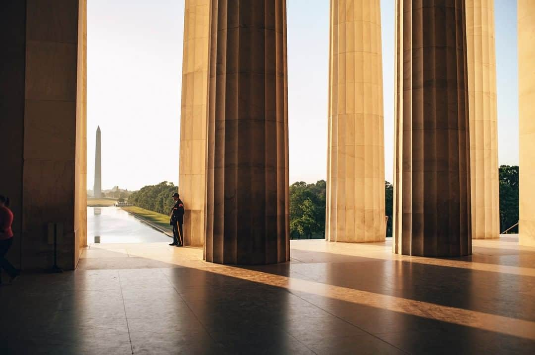 National Geographic Travelさんのインスタグラム写真 - (National Geographic TravelInstagram)「Photo by @joshuacogan | A security guard peers out from the Lincoln Memorial to the Washington Monument at daybreak in Washington, D.C.」3月25日 17時08分 - natgeotravel