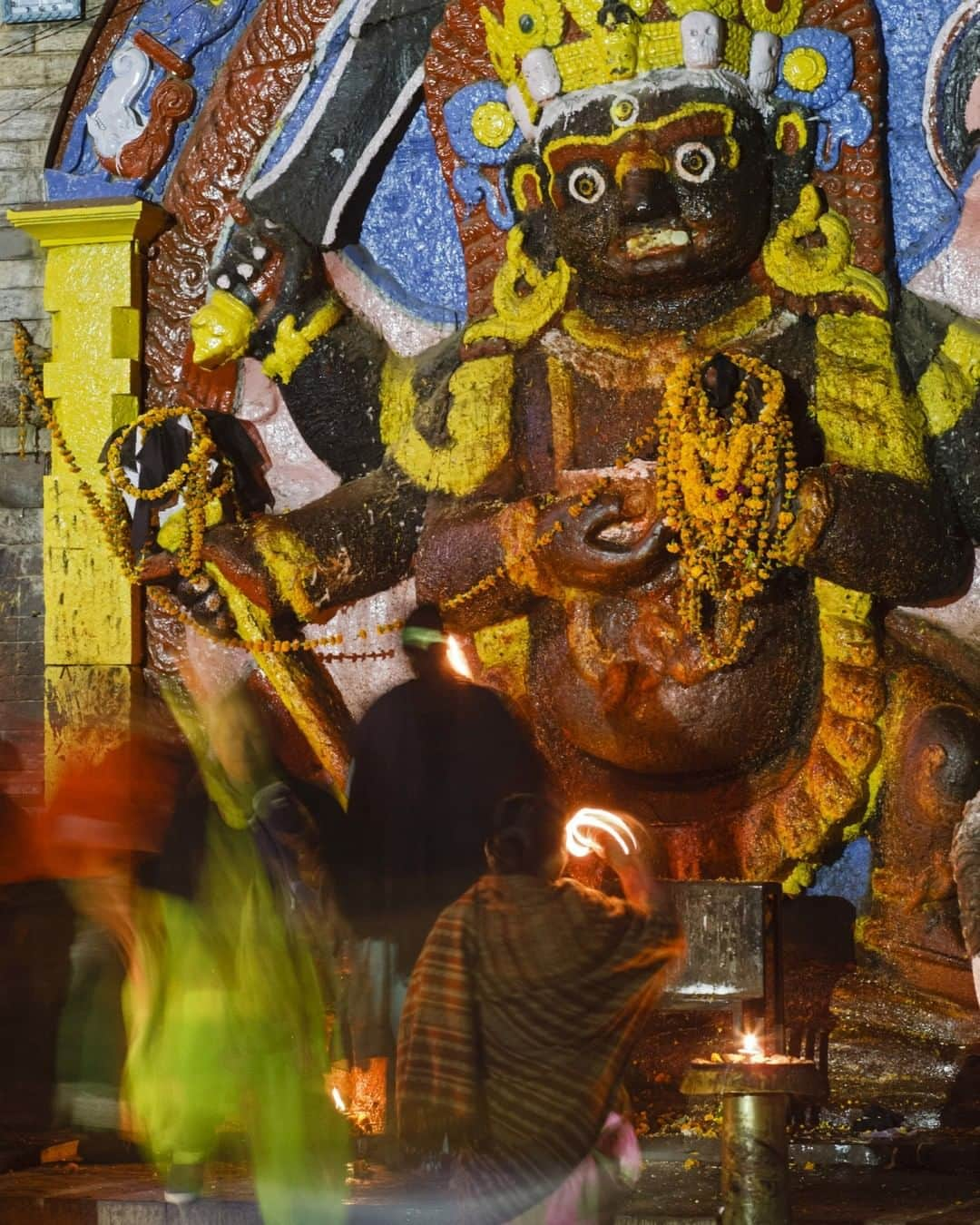 National Geographic Travelさんのインスタグラム写真 - (National Geographic TravelInstagram)「Photo by @babaktafreshi | It was about 6 a.m. in Kathmandu and still dark. I was walking in Durbar Square exploring the city's historic heart at dawn. On one side the prayers were lighting candles for the 12-foot (3.7-meter) statue of the Hindu god Kala Bhairava, a fierce manifestation of Shiva. The Kathmandu Valley is a World Heritage site filled with ancient temples.  Explore more of the world at night with me @babaktafreshi. #nepal #kathmandu #religion」3月26日 1時06分 - natgeotravel