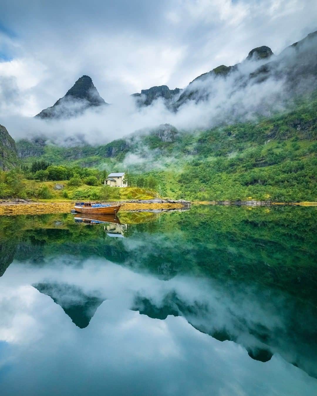 National Geographic Travelさんのインスタグラム写真 - (National Geographic TravelInstagram)「Photo by @michaelclarkphoto | A cloudy Arctic summer morning in Trollfjord in the Lofoten Islands in northern Norway. On this morning we awoke on our sailboat and saw this mirror image once we came on deck. It was still a little dark and it was difficult to get a steady image while standing on the boat. Regardless, it was a magical morning and a home run photo op. #lofoten #norway #trollfjord」3月27日 5時06分 - natgeotravel
