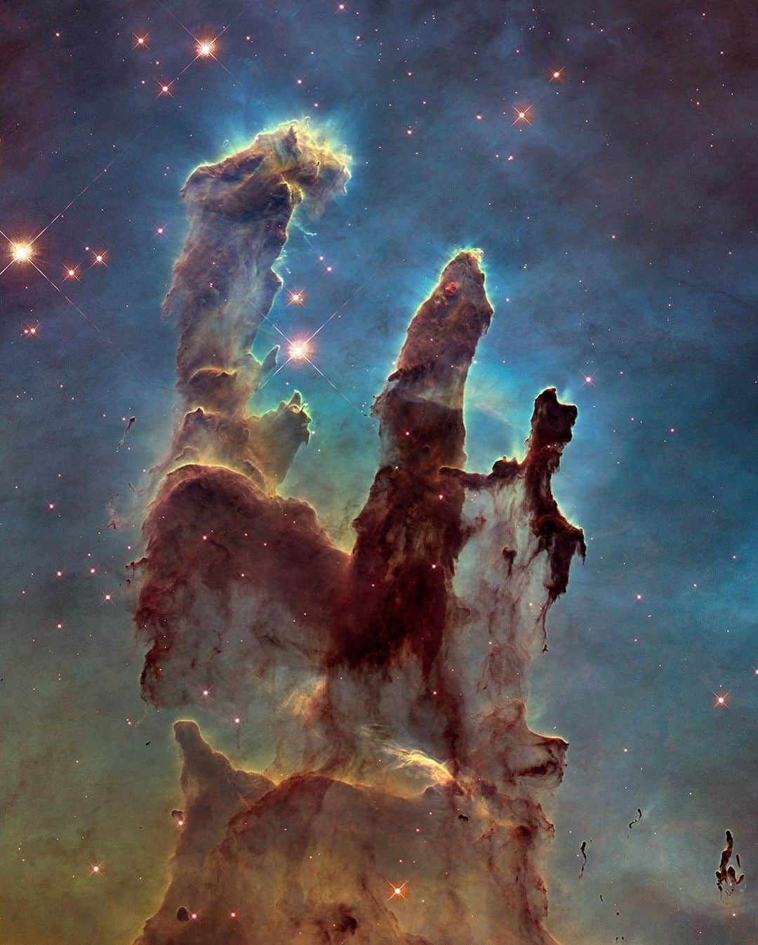 NASAさんのインスタグラム写真 - (NASAInstagram)「Sometimes... there’s more than meets the eye. 👀 Swipe to reveal two very different takes on an iconic image. ⁣ ⁣ In the first image, researchers revisited one of @NASAHubble's most popular sights: the Eagle Nebula’s Pillars of Creation. Here, the pillars are seen in infrared light, which pierces through obscuring dust and gas and unveil a more unfamiliar — but just as amazing — view of the pillars. ⁣ ⁣ The entire frame is peppered with bright stars and baby stars are revealed being formed within the pillars themselves. Swipe left to view the same image in visible light.⁣ ⁣ Image Credit: NASA, ESA/Hubble and the Hubble Heritage Team⁣ ⁣ #NASA #PillarsOfCreation #Suprises #Swipe #Universe⁣」4月7日 6時41分 - nasa