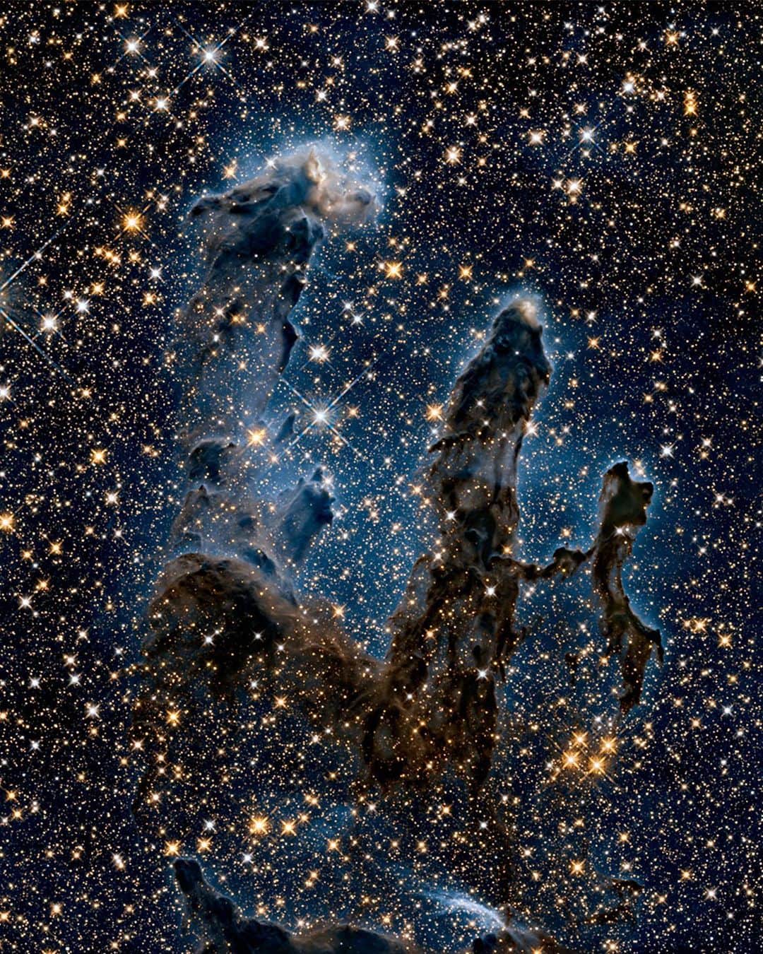 NASAさんのインスタグラム写真 - (NASAInstagram)「Sometimes... there’s more than meets the eye. 👀 Swipe to reveal two very different takes on an iconic image. ⁣ ⁣ In the first image, researchers revisited one of @NASAHubble's most popular sights: the Eagle Nebula’s Pillars of Creation. Here, the pillars are seen in infrared light, which pierces through obscuring dust and gas and unveil a more unfamiliar — but just as amazing — view of the pillars. ⁣ ⁣ The entire frame is peppered with bright stars and baby stars are revealed being formed within the pillars themselves. Swipe left to view the same image in visible light.⁣ ⁣ Image Credit: NASA, ESA/Hubble and the Hubble Heritage Team⁣ ⁣ #NASA #PillarsOfCreation #Suprises #Swipe #Universe⁣」4月7日 6時41分 - nasa
