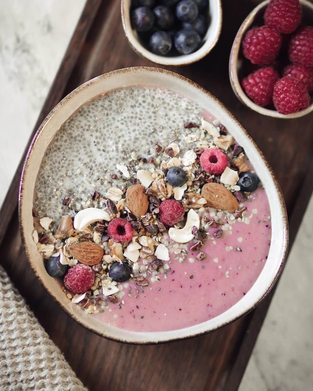 Anna Nyströmのインスタグラム：「Half chia bowl, half berry bowl 💗 Made this with my products from @svenskhalsokost today and it turned out so delicious! 😍 I made an overnight chia pudding with some oat milk and natural vanilla powder, then made a 50/50 bowl with a mixed berry & açaí smoothie. Super easy, healthy & nutritious! Here is the recipe:⁣ ⁣ Ingredients:⁣ ⁣ The chia half:⁣ • Overnight chia pudding (1,5 tbsp chia seeds with oat milk and a pinch of organic vanilla, let rest in fridge overnight)⁣ The smoothie half:⁣ • 1/2 banana⁣ • 1 tsp açaí powder ⁣ • Frozen strawberries ⁣ • Blueberries ⁣ • Raspberries ⁣ • 1/2 cup oat milk (or almond milk)⁣ • 1 tsp honey 🍯 ⁣ ⁣ Topping: Almonds, cashews, walnuts, hemp seeds, cacao nibs & some extra blueberries & raspberries ⁣ ⁣ 1. Take the overnight chia pudding out of the fridge and put it in a bowl (only half of the bowl)⁣ 2. Mix all the smoothie ingredients and then fill up the rest of the bowl! ⁣ 3. Top it with your favorite seeds, nuts & berries. Enjoy! 💗⁣」