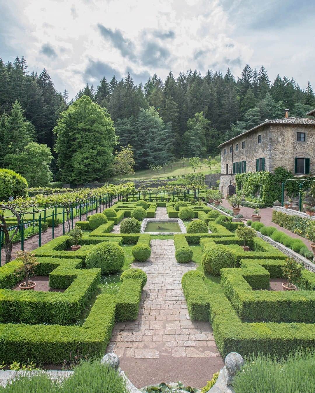 National Geographic Travelさんのインスタグラム写真 - (National Geographic TravelInstagram)「Photo by @andrea_frazzetta | The renaissance garden of Badia a Coltibuono. The former monastery of Badia a Coltibuono is  located in the Chianti, the famous Italian wine zone of Tuscany, not far from the city of Siena. In years gone by Badia a Coltibuono was a monastery providing hospitality to wayfarers. The Abbey was extensively developed under the patronage of Lorenzo dei Medici. It was subsequently transformed into a farmhouse-villa, and has retained its agricultural function ever since. The Badia a Coltibuono garden is laid out in the form of the ancient "hortus conclusus", or "enclosed garden", with geometrical box hedge divisions around beds planted with aromatic and medicinal plants. To see more photos from my travels, follow me @andrea_frazzetta #tuscany #italy」8月10日 16時03分 - natgeotravel