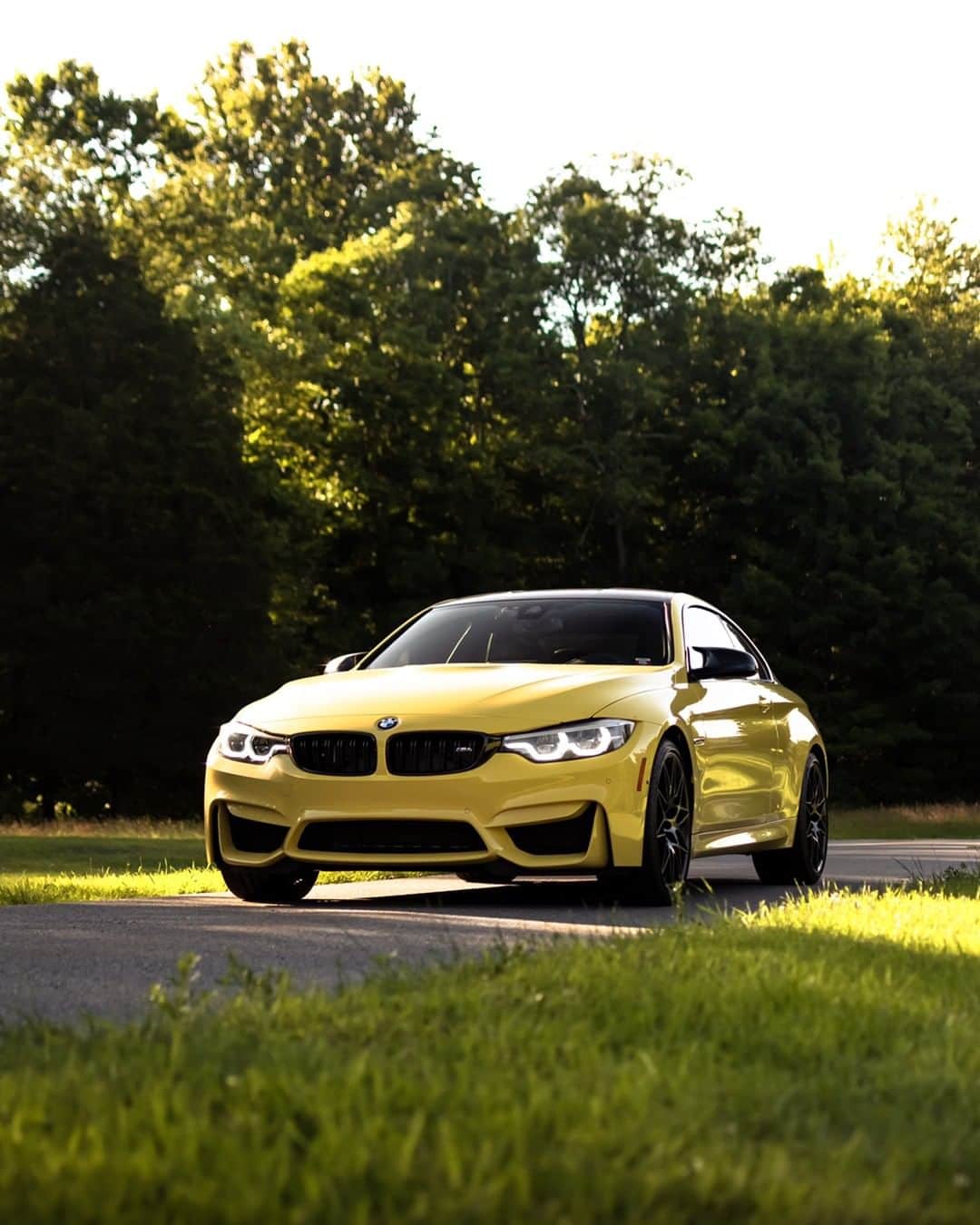 BMWのインスタグラム：「Quicker than a ray of light. The BMW M4 Coupé. #TheM4 #BMW #M4 #BMWM #BMWrepost @CGERM_ @autoangles __ BMW M4 Coupé: Fuel consumption in l/100 km (combined): 10.0 (9.3). CO2 emissions in g/km (combined): 227 (213). Acceleration (0-100 km/h): 4.3 s. Power: 431 hp, 550 Nm. Top speed (limited): 250 km/h. Paint finish shown: Dakar Yellow.  The figures in brackets refer to the vehicle with seven-speed M double-clutch transmission with Drivelogic. The values of fuel consumptions, CO2 emissions and energy consumptions shown were determined according to the European Regulation (EC) 715/2007 in the version applicable at the time of type approval. The figures refer to a vehicle with basic configuration in Germany and the range shown considers optional equipment and the different size of wheels and tires available on the selected model. The values of the vehicles are already based on the new WLTP regulation and are translated back into NEDC-equivalent values in order to ensure the comparison between the vehicles. [With respect to these vehicles, for vehicle related taxes or other duties based (at least inter alia) on CO2-emissions the CO2 values may differ to the values stated here.] The CO2 efficiency specifications are determined according to Directive 1999/94/EC and the European Regulation in its current version applicable. The values shown are based on the fuel consumption, CO2 values and energy consumptions according to the NEDC cycle for the classification. For further information about the official fuel consumption and the specific CO2 emission of new passenger cars can be taken out of the „handbook of fuel consumption, the CO2 emission and power consumption of new passenger cars“, which is available at all selling points and at https://www.dat.de/angebote/verlagsprodukte/leitfaden-kraftstoffverbrauch.html.」