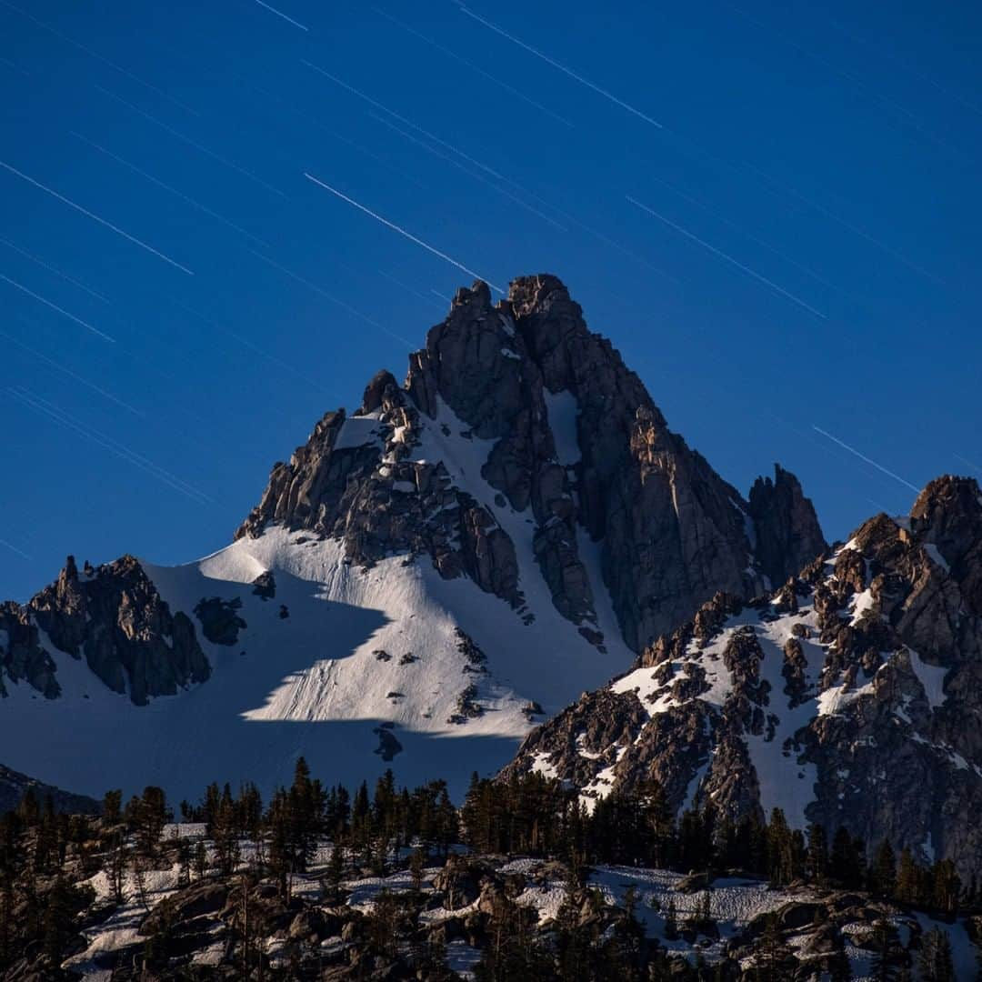 National Geographic Travelさんのインスタグラム写真 - (National Geographic TravelInstagram)「Photo by @BabakTafreshi | In this night of June, through a telephoto lens, I was watching this 13,000-foot (4000-meter) peak in Sierra Nevada, California. A surreal view was emerging as the rising moon hit the rugged peaks. Photographed here is a single exposure of 5 minutes revealing startrails (Earth rotation). Explore more of The World at Night photography with me @babaktafreshi. ⁣#saveournightsky #twanight #sierra #longexposure」8月7日 16時04分 - natgeotravel