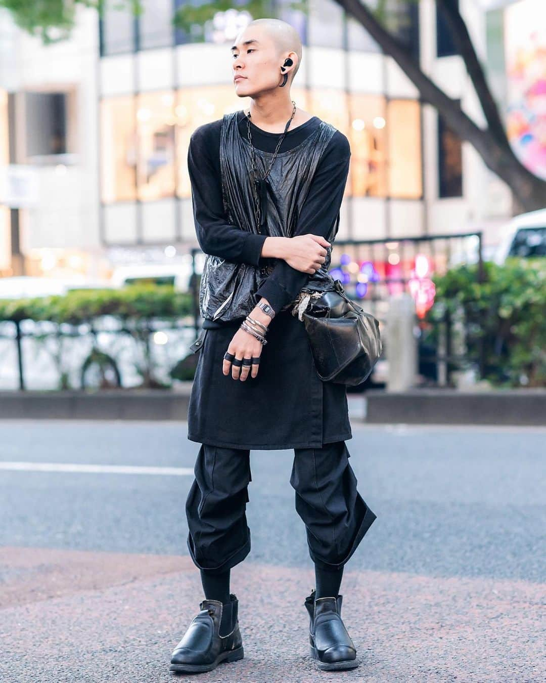 Harajuku Japanさんのインスタグラム写真 - (Harajuku JapanInstagram)「Muneyuki (@offstreet_1_1000) on the street in Harajuku wearing a dark vintage and remake look with a shiny tank over long tee, skirt over cropped pants, a deconstructed leather waist bag, and boots.」8月8日 3時11分 - tokyofashion