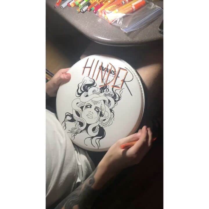 ヒンダーのインスタグラム：「Our talented Mike customizing our drum heads - you can find them at the merchandise shop at one of our shows 🥁🥁」