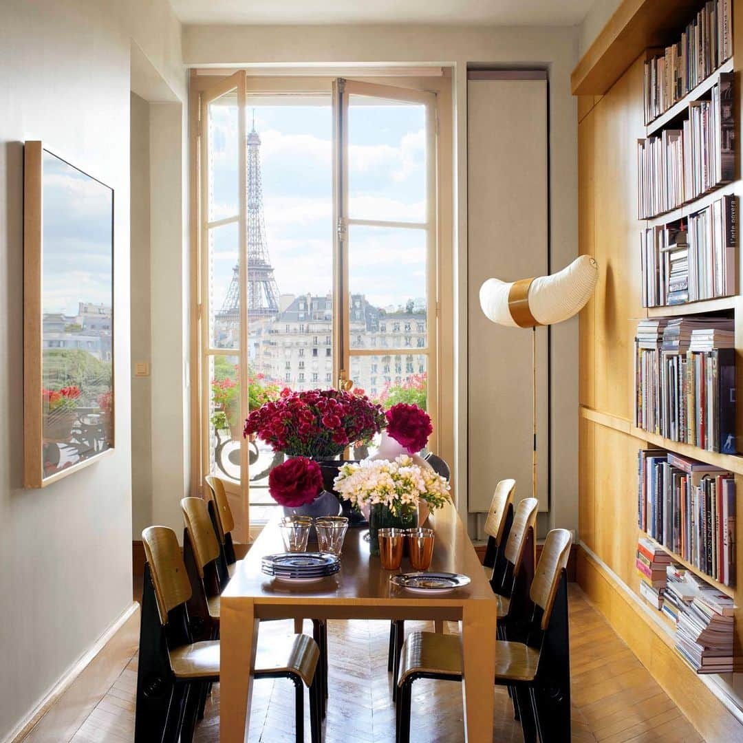 ELLE DECORさんのインスタグラム写真 - (ELLE DECORInstagram)「Every window in @aerin's stunning Paris apartment faces the Eiffel Tower. Her cozy dining room showcases the beauty of the city and serves as a gathering spot for family. The space is furnished with a custom table and circa-1930 cafeteria chairs by Prouvé, along with a vintage Isamu Noguchi Akari lamp. Click the link in bio for the full tour, as seen in our September 2019 issue. Photography by @pascalchevallier; Produced by @cynthiaefrank.」8月9日 6時04分 - elledecor