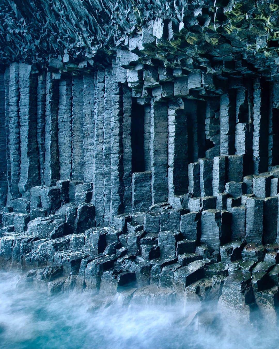 National Geographic Travelさんのインスタグラム写真 - (National Geographic TravelInstagram)「Photo by @jimrichardsonng | Inside Fingal’s Cave on Staffa Island in Scotland, the Basalt columns echo the sea that has battered and eroded its way into the island. But these columns survived better than the dinosaurs who went extinct about the same time this vast lava flow of the Paleocene was reshaping what would become Scotland and Ireland. Small wonder Jules Verne referred to this place in his novel "Journey to the Center of the Earth." #scotland #hebrides」7月18日 4時04分 - natgeotravel