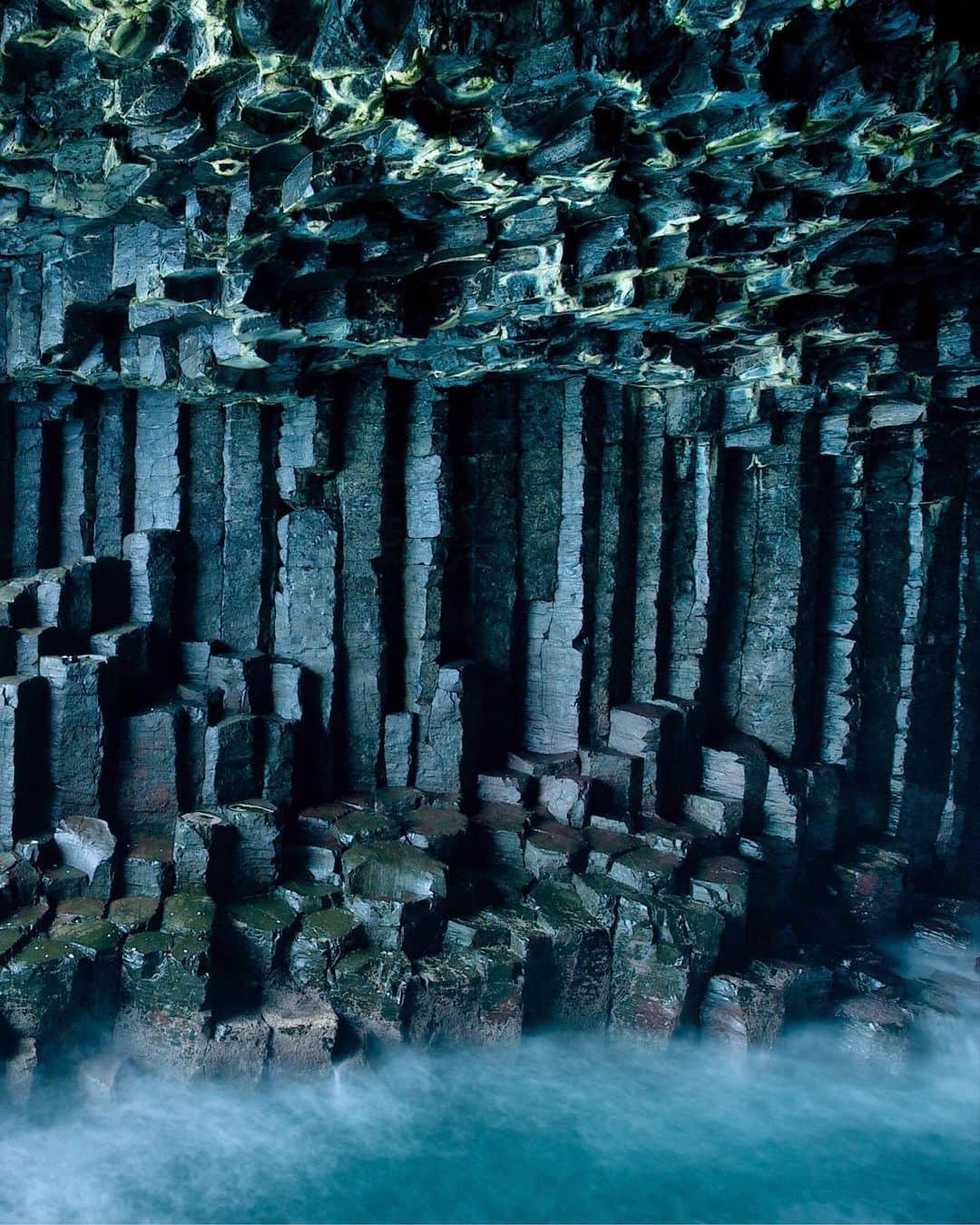 National Geographic Travelさんのインスタグラム写真 - (National Geographic TravelInstagram)「Photo by @jimrichardsonng | Inside Fingal’s Cave on Staffa Island in Scotland, the Basalt columns echo the sea that has battered and eroded its way into the island. But these columns survived better than the dinosaurs who went extinct about the same time this vast lava flow of the Paleocene was reshaping what would become Scotland and Ireland. Small wonder Jules Verne referred to this place in his novel "Journey to the Center of the Earth." #scotland #hebrides」7月18日 4時04分 - natgeotravel