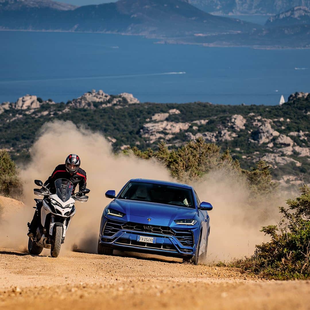 ランボルギーニのインスタグラム：「It's when two great ways of conceiving style come together that you find the road to excellence. That’s what we did with Lamborghini Urus and @ducatimotor Multistrada. Thanks to its ANIMA Selector, Lamborghini Urus can easily enter TERRA Mode and ensure comfort and ease even in off-road conditions.  #Lamborghini #Urus #SinceWeMadeItPossible #Sardinia」