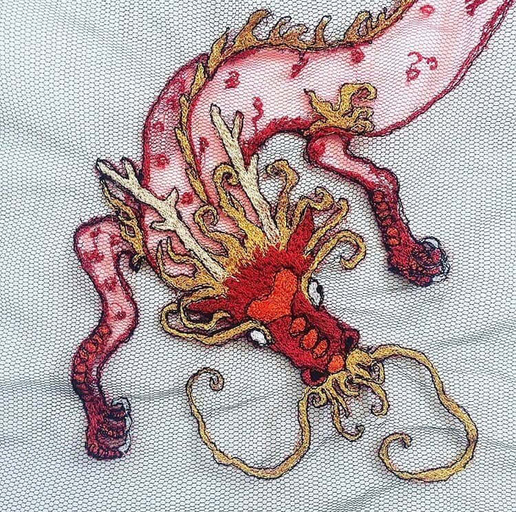 のインスタグラム：「#closeup of one of our dragons in collaboration with @rosiebeard for the #DRAGONSGATE series #🐲 #🐉 #🔥 | Hand embroidered and later embellished with bugle beads, sequins and @swarovski crystals | #piersatkinson #oneofakind #bespoke #dragon」