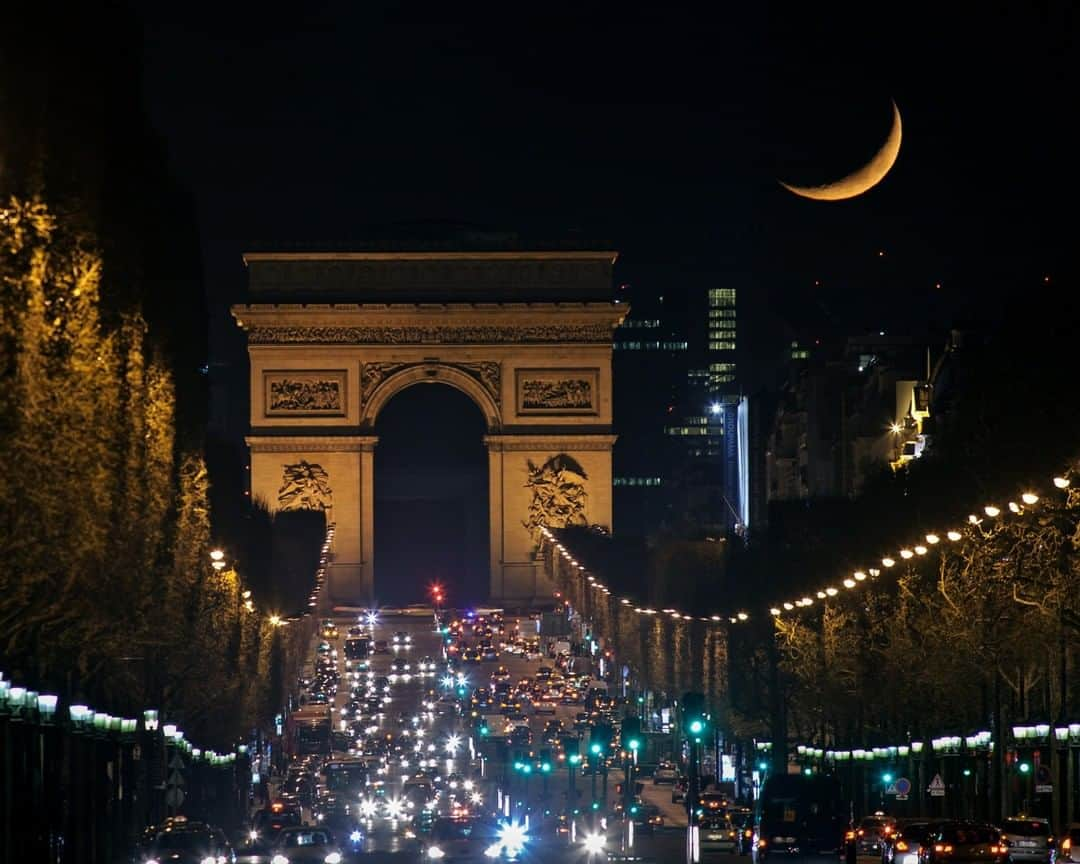 National Geographic Travelさんのインスタグラム写真 - (National Geographic TravelInstagram)「Photo by @BabakTafreshi | On this late evening in March 2012 I was waiting for the moon to align with Champs-Elysees avenue in Paris, as it was setting over Arc de Triomphe (Etoile). We are so used to the moon presence that often forget its cosmic identity. How bizarre it is to see another world so easily and strikingly in the sky, from 400,000 km away. For a car traveling nonstop at 100km/hr highway speed it takes 6 months to travel the distance. This month 50 years ago Apollo 11 astronauts traveled 3 days in space to reach the moon and prepare for the first ever landing on July 20, 1969. Explore more of The World at Night photography with me @babaktafreshi. #twanight #moon #apollo #paris #nightphotography」7月20日 22時03分 - natgeotravel