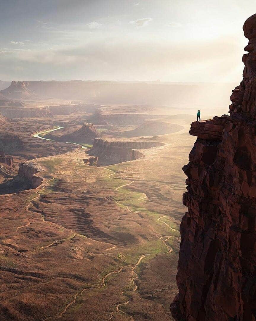 Discover Earthさんのインスタグラム写真 - (Discover EarthInstagram)「"By far, one of my favorite evenings of photography in a very, very, long time. It all took place in a magical area of Utah. I will not disclose this location however, due to the nature of this photograph in which Abby is depicted near the edge of a very large drop off. I don’t need to be responsible for encouraging others to copy this shot! Now while this may look insanely dangerous (which it can be whenever you’re near any drop off), @abbygomer was much further from the actual edge than it appears. The shelf she is standing on wraps behind the edge with plenty of walking space and a nice little trail to get there. It’s all about perspective. . Ok, back to the experience of this evening and what made it so amazing. First off, the views are “holy freaking cow!” The weather was beautifully warm and the sunlight was scrumpshish. Also, this composition worked out to be an absolute stunner, so there was that added element of “I can’t believe I’m capturing this right now!” going through my head. I may have even said this at least 20 times out loud. After photographing this spot around the start of golden hour, we saw another composition a few hundred yards further down the canyon rim that caught our eyes. - Therefore, we decided to scout for a nice sunset composition to wrap up the evening. Little did we know, we were in for one heck of a light and color show. Take in the views from the photo above, and admire how stunningly epic Abby looks standing on top of the world." 🇺🇸 — 📍#DiscoverUtah — 📸 Caption & photo by @benstraussphotography」7月22日 1時58分 - discoverearth