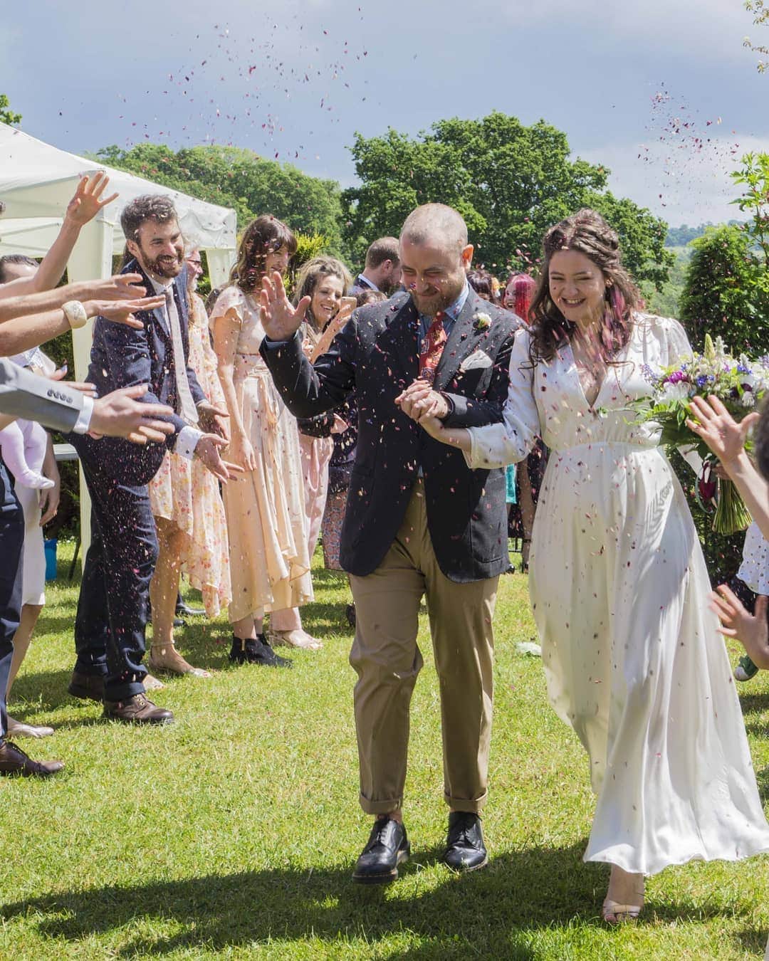 のインスタグラム：「Summer weddings and rose petals in your hair ❤️ In Lucy's beautiful wedding the guests threw biodegradable confetti made of dried rose petals and other flowers. We made Lucy's Olivia silk dress in ivory instead of the original cream as she preferred that and we love it!」
