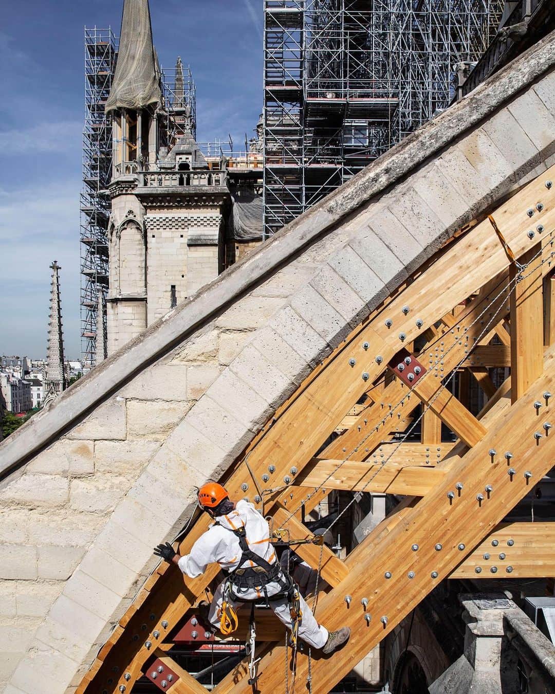 TIME Magazineさんのインスタグラム写真 - (TIME MagazineInstagram)「The destruction of the #NotreDame cathedral in April seemed to many like a turning point. It was “the drop of water that made the vase overflow,” Thierry Paul Valette, one of the Yellow Vest leaders in #Paris, tells Vivienne Walt. With the French in collective grief, President Macron went on television the next day to appeal for national unity and vowed to have it rebuilt within five years. The weekly protests have abated, with demonstrators exhausted from eight months of battle. But the place of worship that 14 million #tourists a year once visited remains a shuttered wreck. The fraught discussion around what comes next for the beloved building cuts to #France’s most sensitive matters of #history and culture, class and political ideology, with questions that will likely take months to resolve. In this photograph, a rope-access technician installs a wooden arch to support a flying buttress on July 22. Read more, and see more #pictures, at the link in bio. Photograph by @pzachmann—@magnumphotos for TIME」7月27日 6時37分 - time