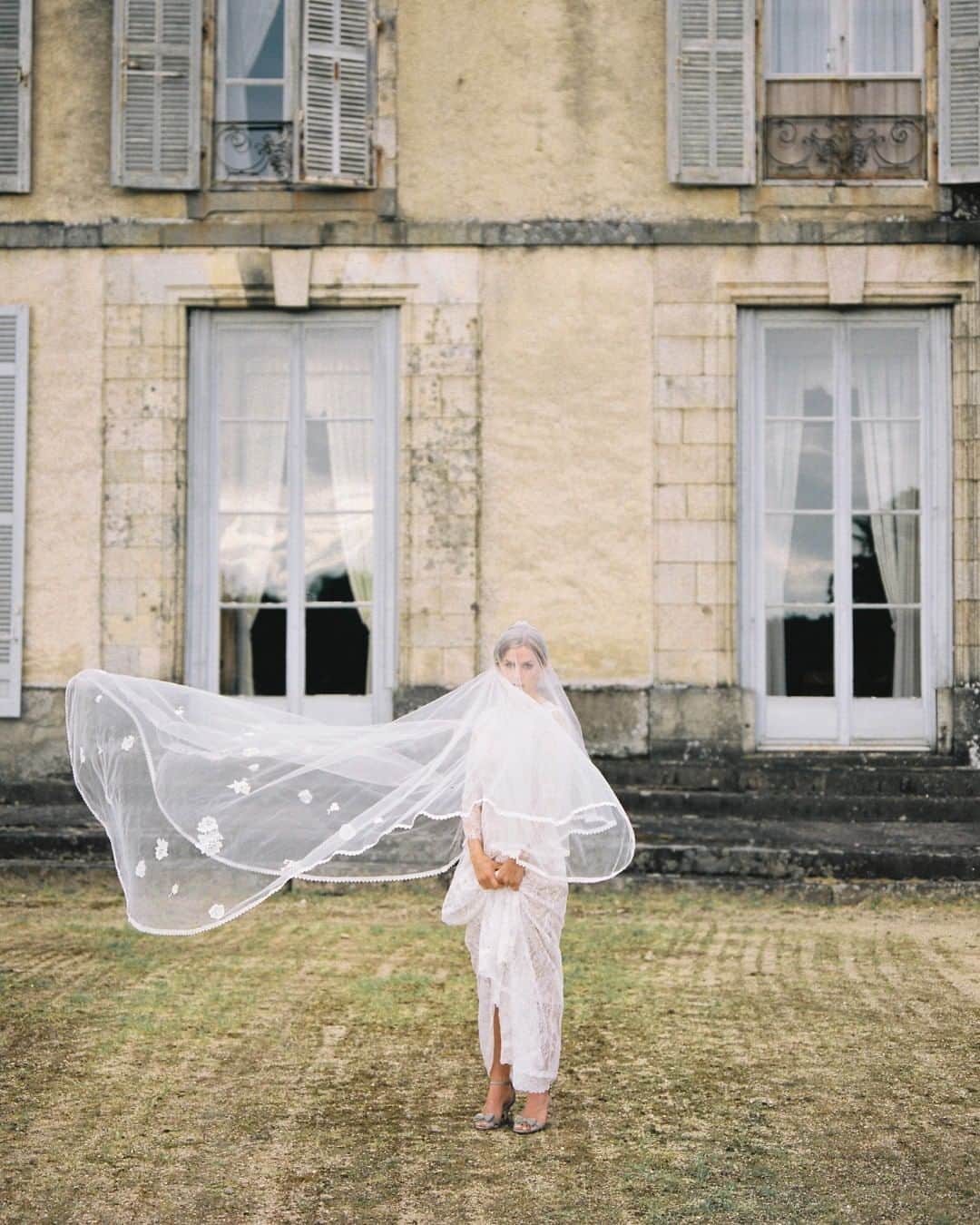 のインスタグラム：「Happy windy Saturday! ❤️ Our gorgeous veils, like this Florence veil (available to try on at the showroom) are handmade as well as the dresses. We use silk tulle to make the veils and embellish them with lace trimming and silk flowers made from silk fabrics remnants from the dress production.  Photography: @alexanderjcollins  Venue: @chateaudebonneval  @laura_cawte  @andthenwegotmarried  @guillaumebernardcreative  @blonde.bonnie  @sw202020」