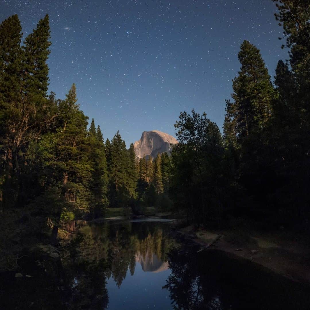 National Geographic Travelさんのインスタグラム写真 - (National Geographic TravelInstagram)「Photo by @BabakTafreshi | Moonlight on Half Dome in a summer night of Yosemite National Park, California. The granite crest rises 4,737 ft (1,444 m) above the valley floor. Stars reflect on the Merced river and Andromeda Galaxy appears at top-left (little elongated halo). Explore more of The World at Night photography with me @babaktafreshi. #saveournightsky #twanight #nationalparks #yosemite」7月28日 1時02分 - natgeotravel