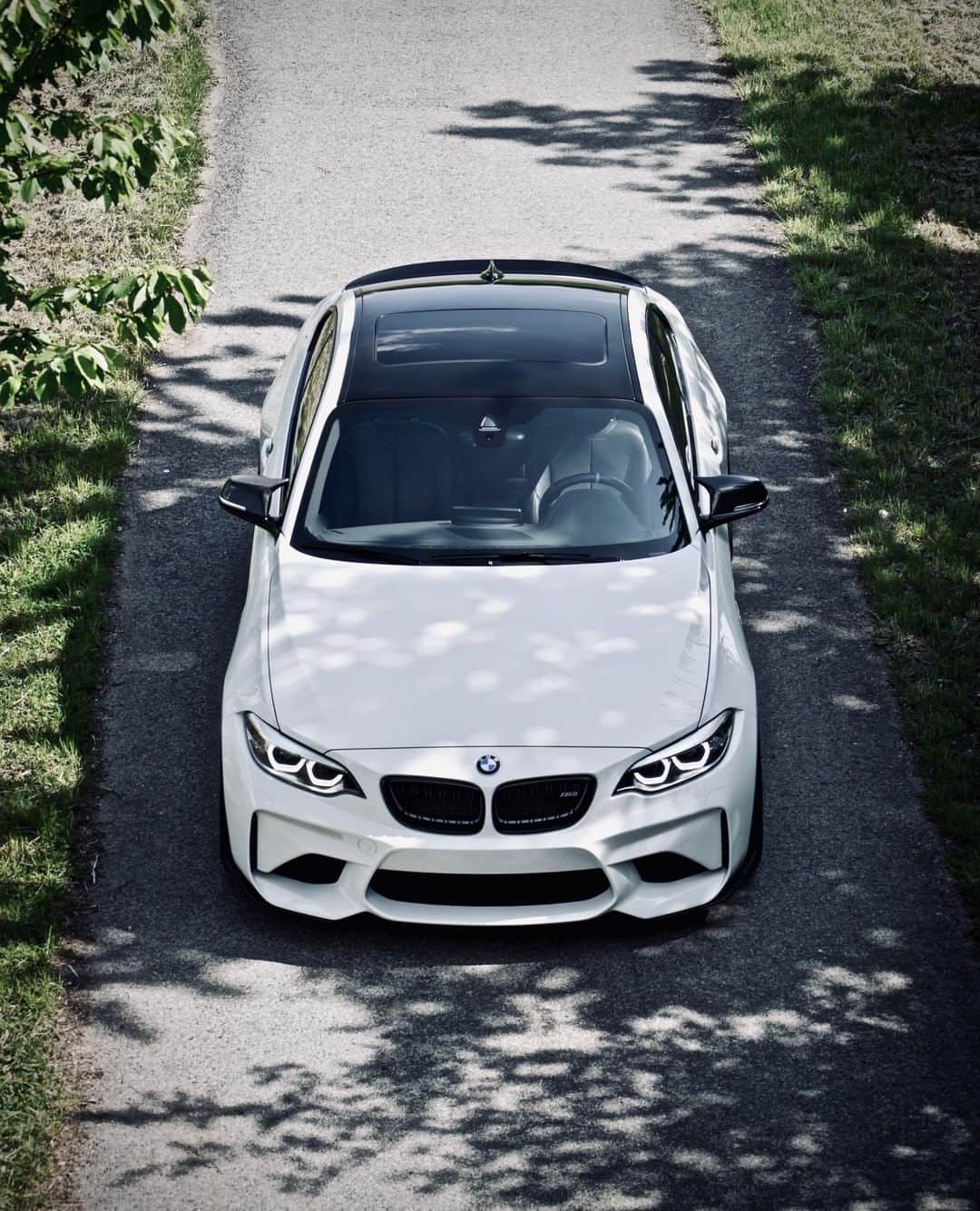 BMWのインスタグラム：「Stimulates the driving experience. The BMW M2 Coupé. #TheM2 #BMW #M2 #BMWM #BMWrepost @white.m2 @maxy_fl __ BMW M2 Coupé: Fuel consumption in l/100 km (combined): 8.5. CO2 emissions in g/km (combined): 199. The values of fuel consumptions, CO2 emissions and energy consumptions shown were determined according to the European Regulation (EC) 715/2007 in the version applicable at the time of type approval. The figures refer to a vehicle with basic configuration in Germany and the range shown considers optional equipment and the different size of wheels and tires available on the selected model. The values of the vehicles are already based on the new WLTP regulation and are translated back into NEDC-equivalent values in order to ensure the comparison between the vehicles. [With respect to these vehicles, for vehicle related taxes or other duties based (at least inter alia) on CO2-emissions the CO2 values may differ to the values stated here.] The CO2 efficiency specifications are determined according to Directive 1999/94/EC and the European Regulation in its current version applicable. The values shown are based on the fuel consumption, CO2 values and energy consumptions according to the NEDC cycle for the classification. For further information about the official fuel consumption and the specific CO2 emission of new passenger cars can be taken out of the „handbook of fuel consumption, the CO2 emission and power consumption of new passenger cars“, which is available at all selling points and at https://www.dat.de/angebote/verlagsprodukte/leitfaden-kraftstoffverbrauch.html.」