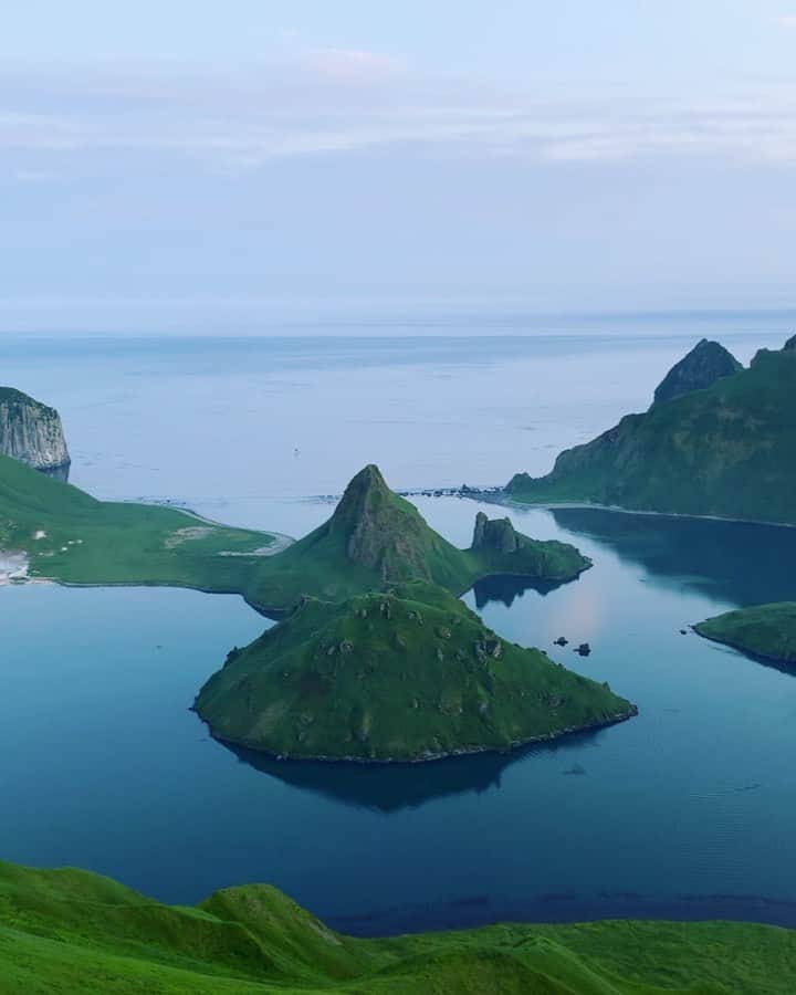 クリス・バーカードのインスタグラム：「To have a completely clear day in Ushishir Island is like winning the lottery. This place is typically so foggy you can’t see the shore from the boat let alone the entire caldera. @tedhesser & I made a plan & pointed it straight out to the highest rim we could find for sunset. I think we both underestimated how steep & long the hike was. Chest deep grass & steep inclines made it feel more like climbing than hiking while we pulled ourselves up by the roots 100% committing to them. When we made it to the rim, sweaty & out of breath we found a large hole that had been dug for the size of a small human to fit .. almost as if a perfect viewing platform protected from the wind. We later found out at the ancient Ainu people would dig holes for fortification throughout these islands. I wondered just how many people had seen this piece of history. .  Shot on iPhone / @olloclip  #fromkurilswithlove  @renan_ozturk @taylorfreesolo @rishisugla @jtkerby @povel @tomorrow_unlocked」