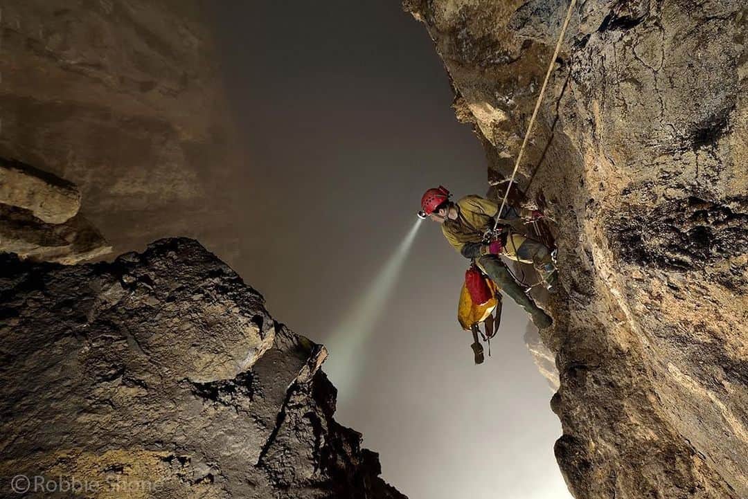 thephotosocietyさんのインスタグラム写真 - (thephotosocietyInstagram)「Photo by @shonephoto (Robbie Shone) | American speleologist and cave explorer Erin Lynch peers over her shoulder and down into the giant void of Cloud Ladder Hall. The fog gathers and remains trapped in the roof of this giant room and although the floor is out of view and can not be seen because of the cloud, her echo reminds her that it is over 300m (1000ft) below. This really is a very lofty location to be suspended from a single rope.」8月1日 6時35分 - thephotosociety