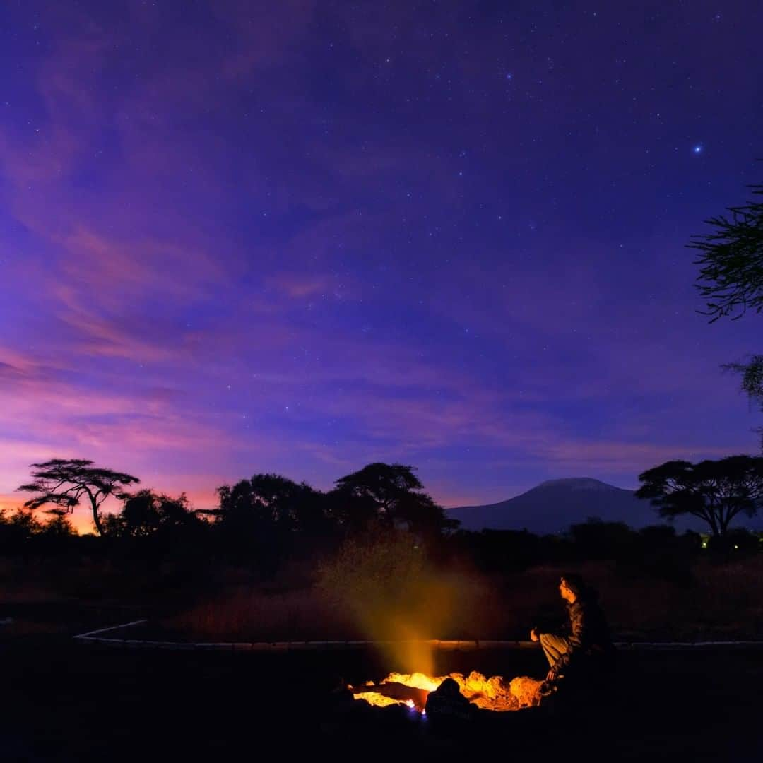 National Geographic Travelさんのインスタグラム写真 - (National Geographic TravelInstagram)「Photo by @BabakTafreshi | After a long night of work under stars it was a relaxing moment by this campfire in Amboseli National Park of southern Kenya, near the border of Tanzania. The morning twilight was emerging above Kilimanjaro, framed between the Acacia trees. In the sky the Southern Cross is in the center left. ⁣Explore more of The World at Night project with me @babaktafreshi. #nightphotography #kilimanjaro #twanight @twanight」8月2日 4時07分 - natgeotravel