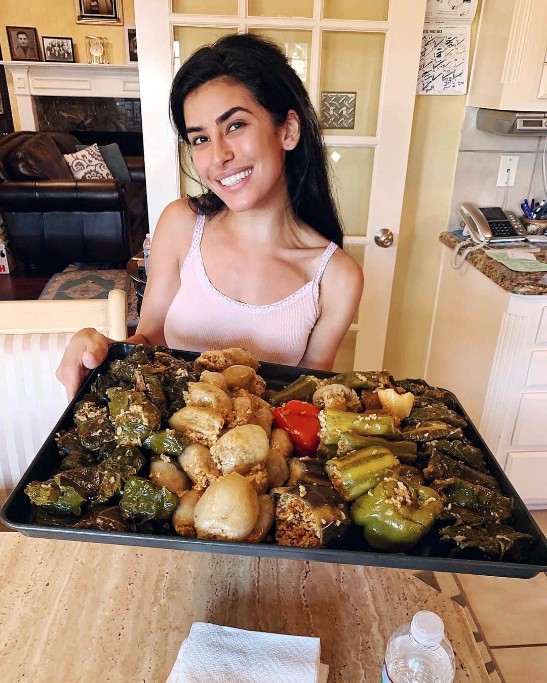 Sazan Hendrixさんのインスタグラム写真 - (Sazan HendrixInstagram)「Cheers to the weekend! I grew up on my mom’s dolma, and in our culture everyone says there’s no dolma like your mom’s dolma! 😂 In our house we always took so many different vegetables (not just grape leaves!) and then stuffed them with the most delicious flavorful rice mix that melts in your mouth🍠🍅 Mine never turns out as good as hers but that’s okay, she always let me practice wrapping as a kid 🤣 love that Steve & teeny love dolma just as much as me ❤️ What is your favorite family dish that you cherish?! Please share with me!! 👇🏼 #mymomisaG #20lbsofdolma #fridaynight #kurdishrecipes」8月3日 7時35分 - sazan