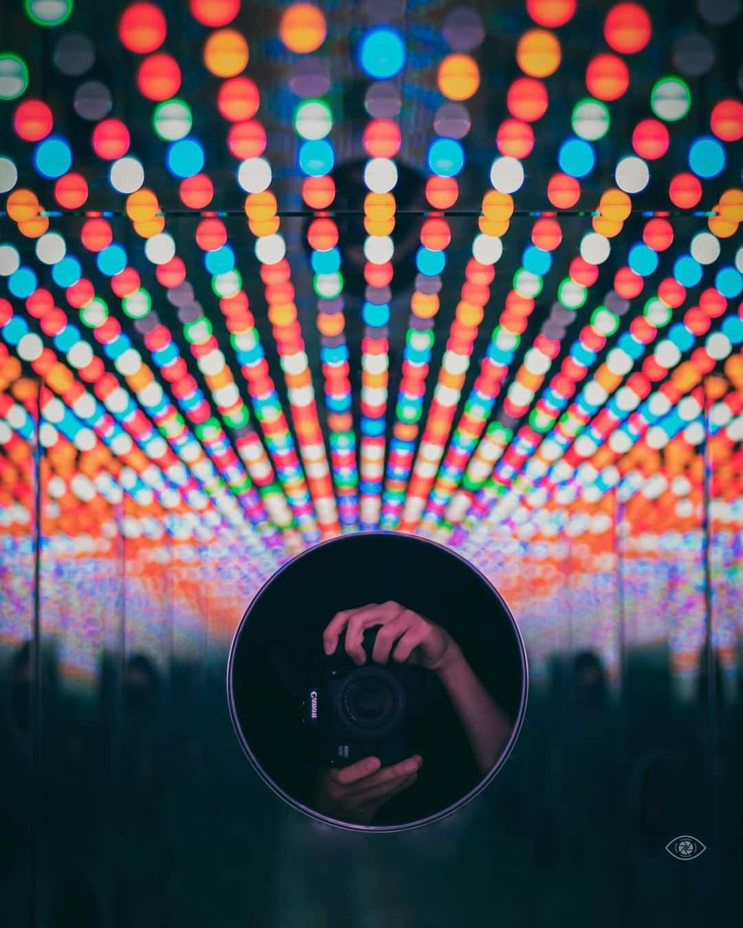 Canon Asiaのインスタグラム：「“This photo was taken during my visit to the 2017 Yayoi Kusama exhibition. I was attracted by the colourful lights pulsating in chaotic patterns within this peculiar art installation. Rows and rows of mirrors reflected an infinity of lights in every direction the viewer faced. I positioned my camera through one of the viewing portholes and took a photo of my camera in its mirrored reflection, with the colorful lights seemingly radiating outwards in a fan shape.  This shot serves as a reminder that a camera enables us to capture the wonderful moments we come across in life, in all its colourful glory . 📷 Image by @eye.follow.rivers shot using the Canon EOS 800D | Canon EF 50mm f/1.8 STM | f/1.8| 1/125s | ISO 100 | 50mm  Want your photos to be featured too? Tag them with #canonasia or submit them on My Canon Story, link in bio!  #canonasia #photography #singapore #igsg #bokeh #bokehphotography #lights #yayoikusama」