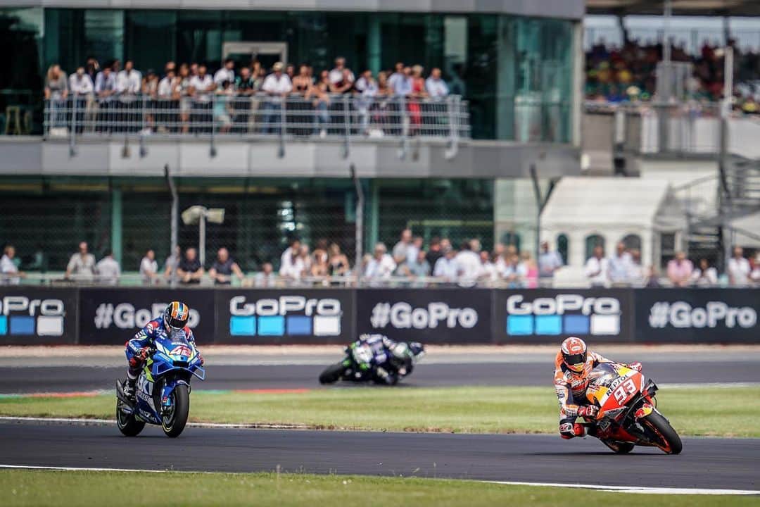 レプソル・ホンダのインスタグラム：「HRC Photographer @cormacgp’s photo of the #BritishGP 🇬🇧 ⠀⠀⠀⠀⠀⠀⠀⠀⠀ “In the last few laps of the race I noticed Maverick Viñales was slowly creeping into the background after each lap. Here with five laps to go Márquez is leading ahead of Rins and Viñales with the crowd in the background, waiting for the fight to begin. It was a hard race to judge as it progressed, but I thought that in the last sector was where the action would be. I just happened to be a few corners early for the action! It was clear to see out on track the different strengths and weaknesses of both rider & ultimately ended in a great fight for the win. The light at this part of the track let me shoot what we call 'wide open' and this is taken at f/2.8, hence the 'softer' look and feel of the picture.” ISO 100, f/2.8, 1/2000.」
