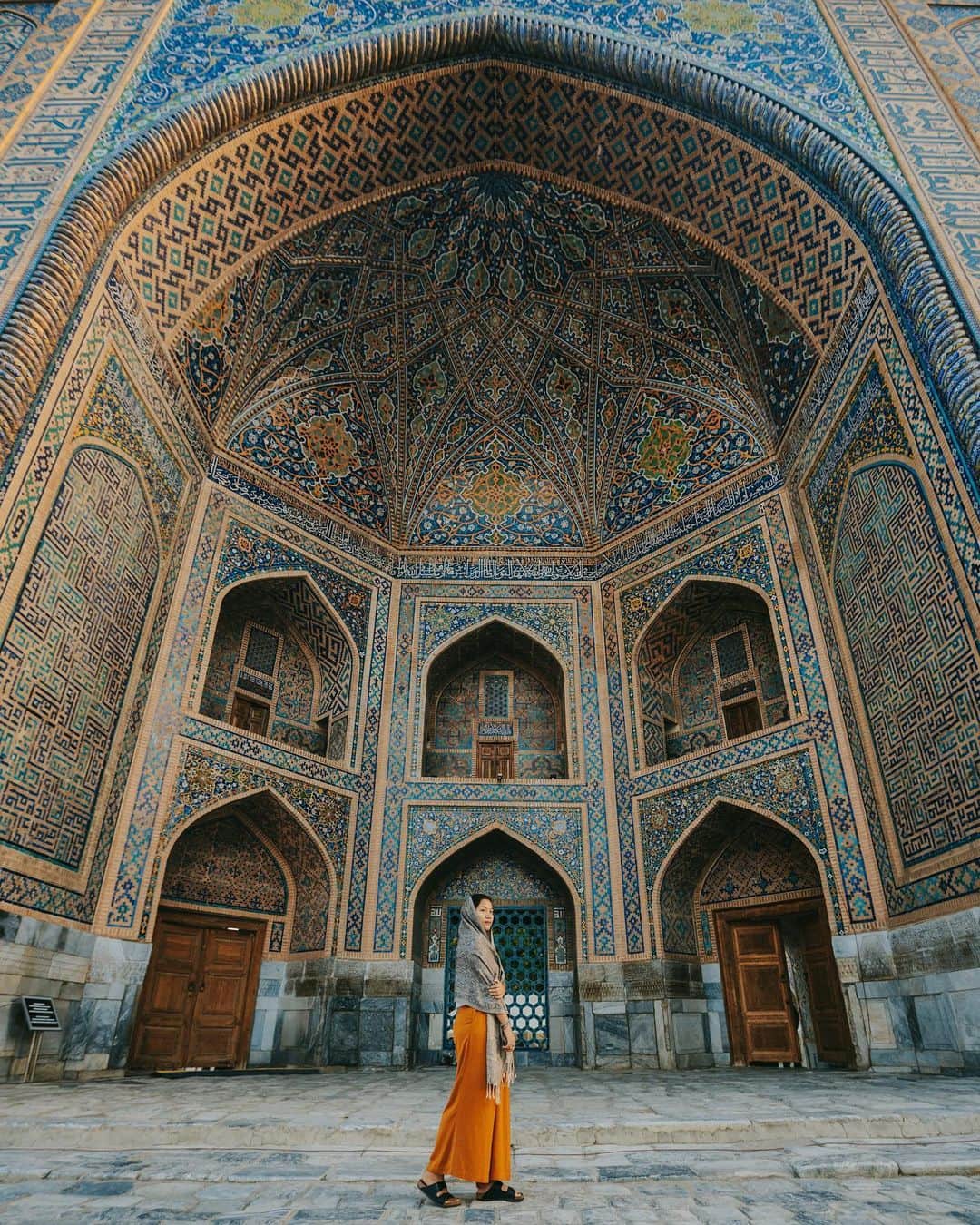 Putri Anindyaのインスタグラム：「An obligatory self portrait in Uzbekistan // today i just read a very interesting articles in Forbes about travel and influencers. I never see myself as one, but the article sure got me good as one of the people in instagram who loves to share places that I visited, from my perspective. . . It is true, that behind this shot there’s a struggle where we had to wake up at 5am in the morning to have this place empty with good light. It is also true that behind this shot, there are some of my friends who were waiting for their turn. It is true that I asked @dotzsoh to take pict of me more than couple times to have perfect shot of myself with long legs and slimmer (thanks to my 16-35mm). It is also very true that I edited this picture with lightroom so the color is different from the reality. There are some efforts to have this kind of photo and it is not that simple. . . While it is also true, as an audience, if we don’t like to see the perfect picture ruined our travel expectations, we can choose not to see it by following the people or media that we really like without this kind of photo. It is also true when you want to travel somewhere, you can’t depend on what you see in instagram! You should read more and do some research on the internet. And it is also very true that my goal when i take pictures is to have my own perspective, to have special frame, something that very personal and sometimes different from the reality. . . So, what do you think about this kind of behaviour? What do you think about the articles? And what do you feel when you see this picture? . . I just hope it cheers your day and make you want to do a research about Registan in Uzbekistan because this place is truly incredible. #visituzbekistan #wicuzbekistan @worldinfluencerscongress」