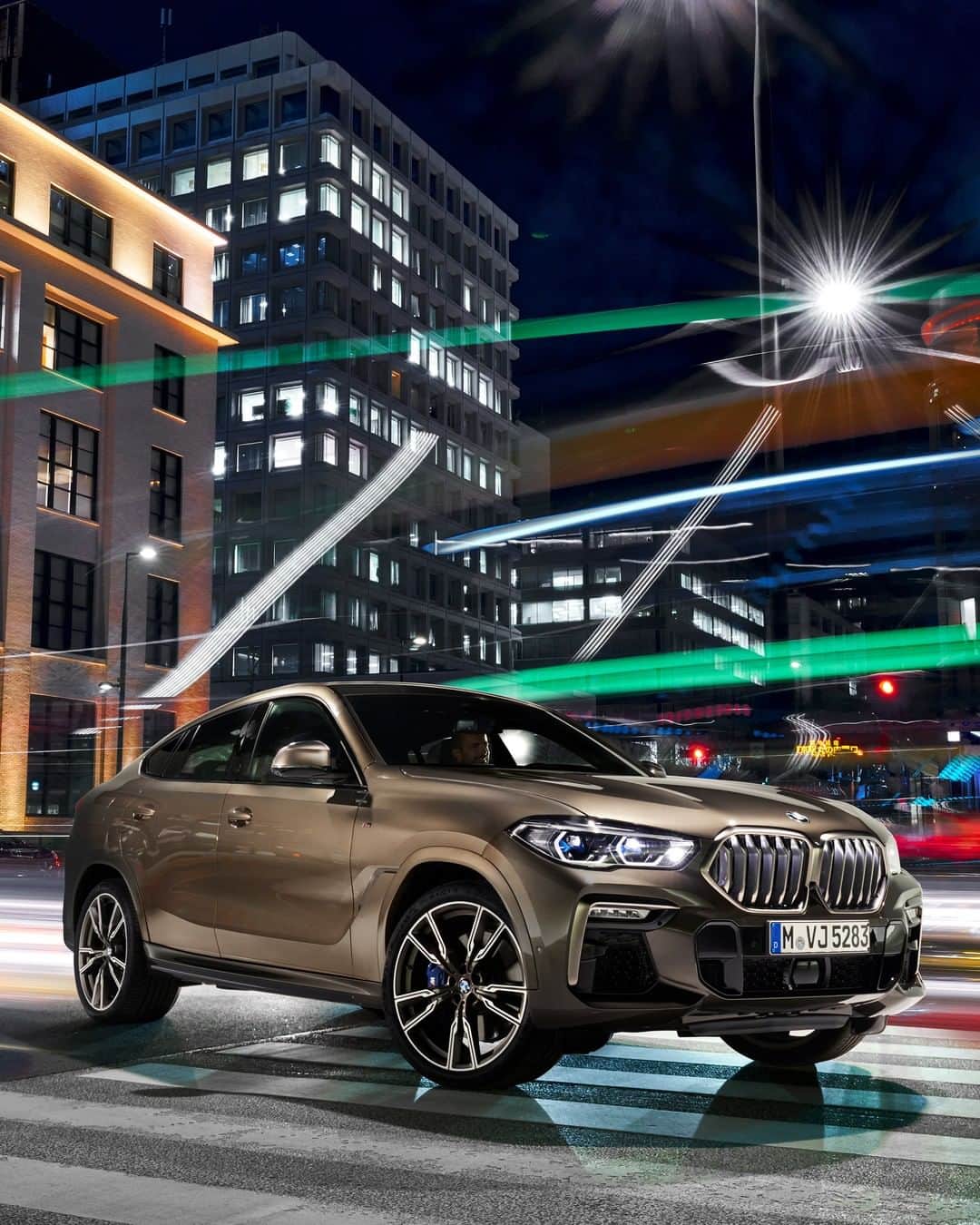 BMWのインスタグラム：「Brighter and more powerful than the street lamps along the avenues. The all-new BMW X6. #TheX6 #BMW #X6 __ BMW X6 M50i: Fuel consumption in l/100 km (combined): 10.7-10.4. CO2 emissions in g/km (combined): 243-237.  Acceleration (0-100 km/h): 4.3 s. Power: 530 hp, 750 Nm. Top speed (limited): 250 km/h. Paint finish shown: Manhattan metallic.  The values of fuel consumptions, CO2 emissions and energy consumptions shown were determined according to the European Regulation (EC) 715/2007 in the version applicable at the time of type approval. The figures refer to a vehicle with basic configuration in Germany and the range shown considers optional equipment and the different size of wheels and tires available on the selected model. The values of the vehicles are already based on the new WLTP regulation and are translated back into NEDC-equivalent values in order to ensure the comparison between the vehicles. [With respect to these vehicles, for vehicle related taxes or other duties based (at least inter alia) on CO2-emissions the CO2 values may differ to the values stated here.] The CO2 efficiency specifications are determined according to Directive 1999/94/EC and the European Regulation in its current version applicable. The values shown are based on the fuel consumption, CO2 values and energy consumptions according to the NEDC cycle for the classification. For further information about the official fuel consumption and the specific CO2 emission of new passenger cars can be taken out of the „handbook of fuel consumption, the CO2 emission and power consumption of new passenger cars“, which is available at all selling points and at https://www.dat.de/angebote/verlagsprodukte/leitfaden-kraftstoffverbrauch.html.」