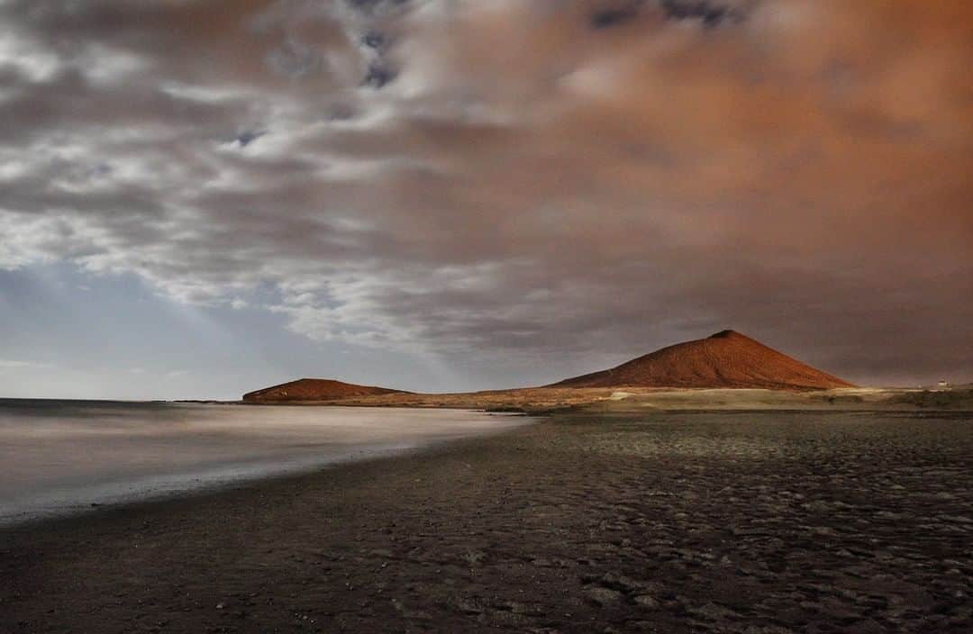 National Geographic Travelさんのインスタグラム写真 - (National Geographic TravelInstagram)「Photo by @andrea_frazzetta | Full moon night over the Playa de El Medano, Tenerife, Canary Islands. A long exposure has created this Martian scenario. El Médano, in the south of Tenerife, is a place of strong winds and a  beach of golden sand. In the background you can see the volcanic cone of the Montana Roja (The Red Mountain), a protected natural reserve. To see more photos from my travels, follow me @andrea_frazzetta #tenerife #canaries #spain」8月12日 13時01分 - natgeotravel