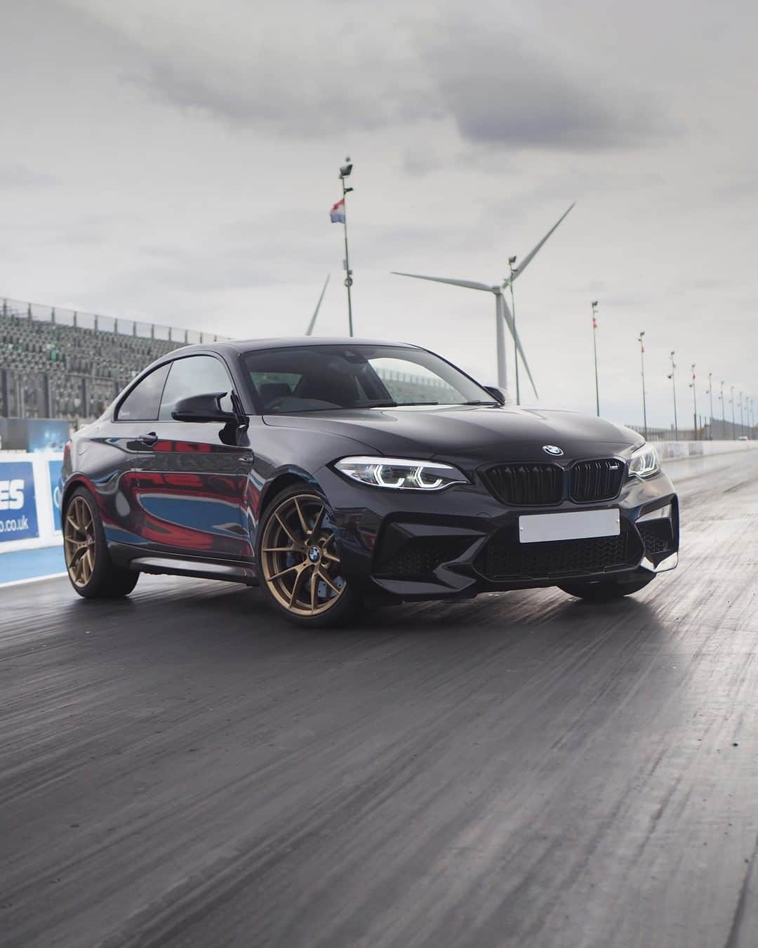 BMWさんのインスタグラム写真 - (BMWInstagram)「Engaged to the track, wearing a fantastic golden ring. The BMW M2 Competition. #TheM2 #BMW #M2 #BMWM #BMWrepost @black.m2c  __ BMW M2 Competition: Fuel consumption in l/100 km (combined): 10.0 (9.2). CO2 emissions in g/km (combined): 227 (209). The figures in brackets refer to the vehicle with seven-speed M double-clutch transmission with Drivelogic. The values of fuel consumptions, CO2 emissions and energy consumptions shown were determined according to the European Regulation (EC) 715/2007 in the version applicable at the time of type approval. The figures refer to a vehicle with basic configuration in Germany and the range shown considers optional equipment and the different size of wheels and tires available on the selected model. The values of the vehicles are already based on the new WLTP regulation and are translated back into NEDC-equivalent values in order to ensure the comparison between the vehicles. [With respect to these vehicles, for vehicle related taxes or other duties based (at least inter alia) on CO2-emissions the CO2 values may differ to the values stated here.] The CO2 efficiency specifications are determined according to Directive 1999/94/EC and the European Regulation in its current version applicable. The values shown are based on the fuel consumption, CO2 values and energy consumptions according to the NEDC cycle for the classification. For further information about the official fuel consumption and the specific CO2 emission of new passenger cars can be taken out of the „handbook of fuel consumption, the CO2 emission and power consumption of new passenger cars“, which is available at all selling points and at https://www.dat.de/angebote/verlagsprodukte/leitfaden-kraftstoffverbrauch.html.」8月13日 5時00分 - bmw
