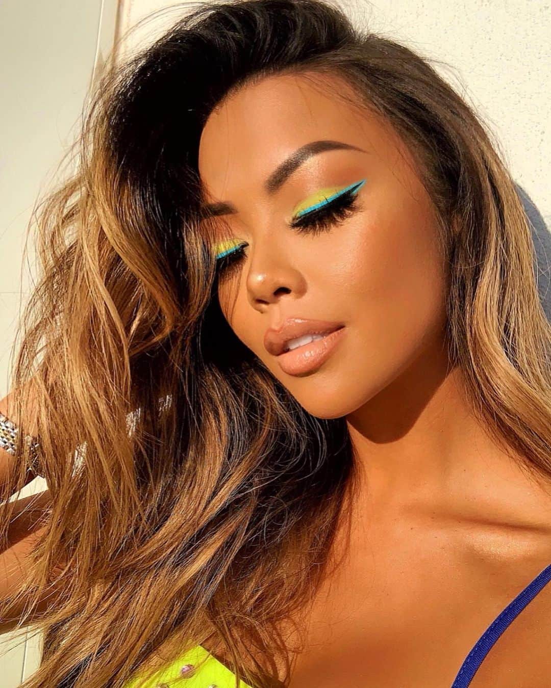 リアン Vのインスタグラム：「N E O N  V I B E S⚡️Had so much fun creating this look! Makeup Deets ⬇️ Full Body bronzed by: @tanyap126  Eyes: @bhcosmetics “Colour Festival” Palette  Eyeliner: @fentybeauty Vivid liquid eyeliner “Hot Tub Club” Brows: @anastasiabeverlyhills Dip Brow “Medium Brown” Foundation: @beccacosmetics “Olive” & @maybelline Dream Urban Cover  Concealer: @tartecosmetics Tape “Medium Tan” Setting Powder: @lauramercier  Bronzer: @benefitcosmetics “Hoola” Highlight: @jcatbeauty “White Goddess” Lips: @lagirlcosmetics Lip liner “Sugar & Spice” @stilazzi lipstick “Sending Nudes” Lip gloss @lunarbeauty “Selene”」