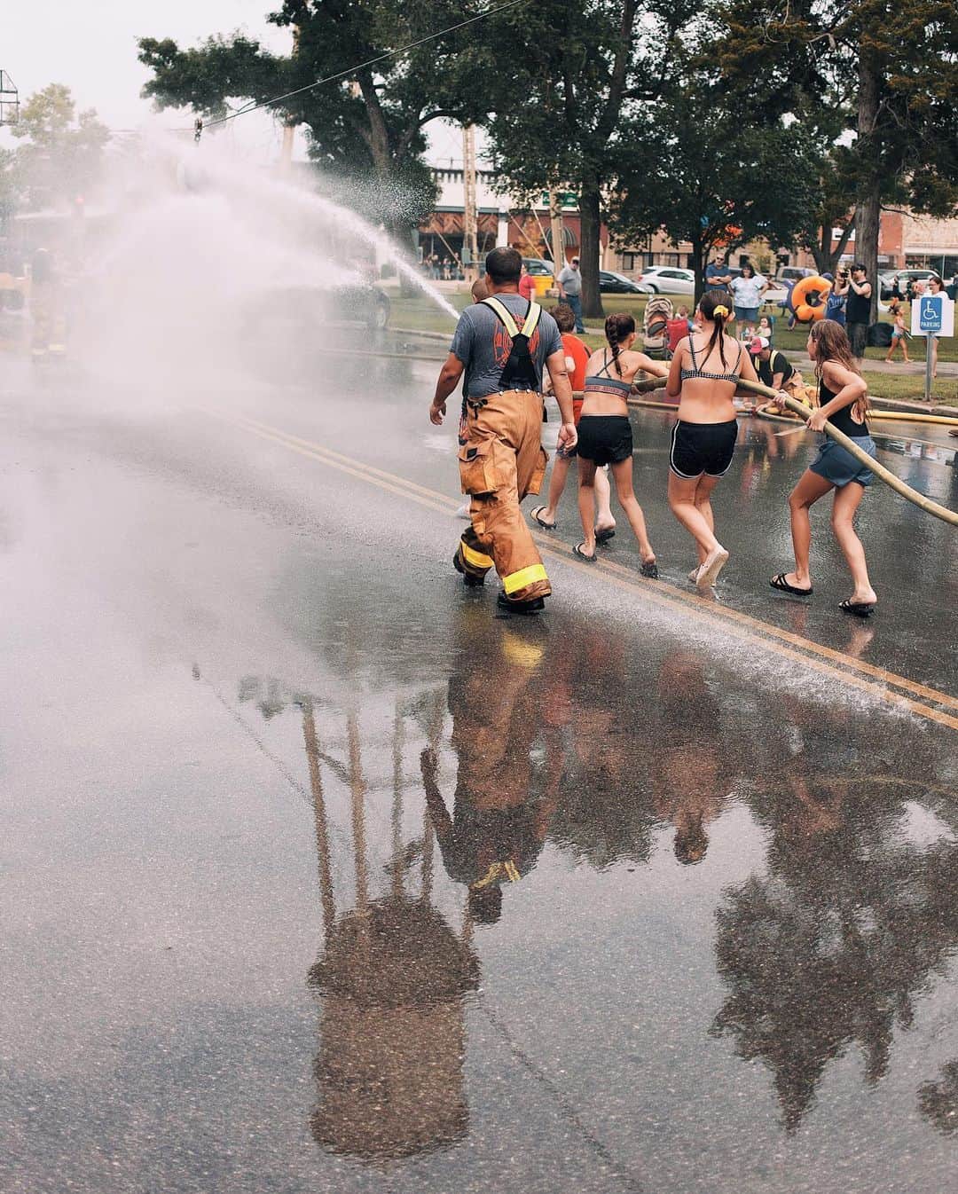 Robert Bingamanのインスタグラム：「Hats off to the people behind @abolderhumboldt. They put on their town’s first “Water Wars” in more than 25 years. Though the branding was a throwback, it struck me as the kind of community event that is desperately needed now—especially in small towns. There were so many great aspects of this event, from a giant foam machine to a massive slip-and-slide to an age-by-age watermelon eating contest. But the parade—complete with 20 water themed (and water emitting) floats, led by fire engines and doused by a throng of some 2,000 water-gun equipped attendees—the parade was “I remember” special. I can’t remember ever seeing that many people acting like (or simply being) happy children.  There’s no catch from @abolderhumboldt, which is not a government entity. They just want a bolder Humboldt. I hope that whatever I end up making for them can live up to their spirit. More frames to come.」