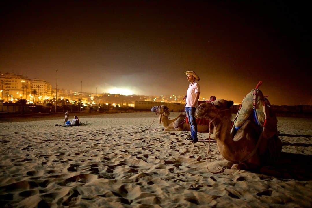 National Geographic Travelさんのインスタグラム写真 - (National Geographic TravelInstagram)「Photo by @mborowick | A camel herder offers rides on the beach in Tangier,  Morocco during the holy month of Ramadan. #ramadan #camel #Morocco #explore #beach」8月15日 13時04分 - natgeotravel