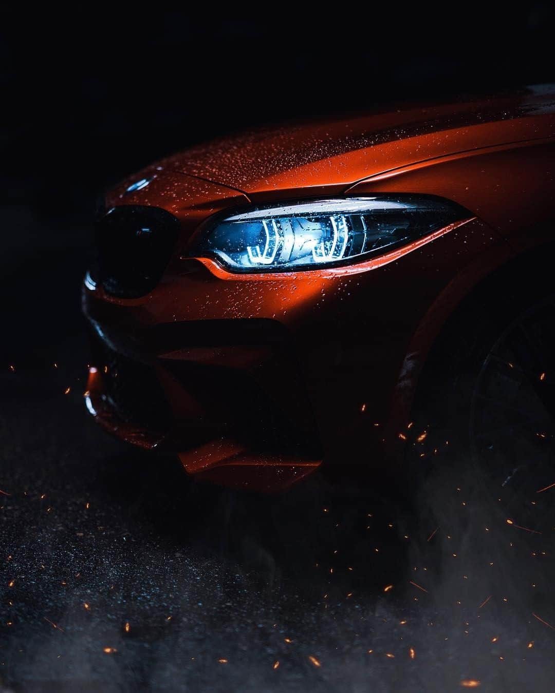 BMWのインスタグラム：「The eye is the window to a powerful soul. The BMW M2 Competition. #TheM2 #BMW #M2 #BMWM #BMWrepost @mpn.photography __ BMW M2 Competition: Fuel consumption in l/100 km (combined): 10.0 [9.2]. CO2 emissions in g/km (combined): 227 [209]. Acceleration (0-100 km/h): 4.2 s. Power: 302 kW, 410 hp, 550 Nm. Top speed (limited): 250 km/h (with optional M Drivers Package: 280 km/h). Paint finish shown: Sunset Orange metallic.  The figures in brackets refer to the vehicle with seven-speed M double-clutch transmission with Drivelogic. The values of fuel consumptions, CO2 emissions and energy consumptions shown were determined according to the European Regulation (EC) 715/2007 in the version applicable at the time of type approval. The figures refer to a vehicle with basic configuration in Germany and the range shown considers optional equipment and the different size of wheels and tires available on the selected model. The values of the vehicles are already based on the new WLTP regulation and are translated back into NEDC-equivalent values in order to ensure the comparison between the vehicles. [With respect to these vehicles, for vehicle related taxes or other duties based (at least inter alia) on CO2-emissions the CO2 values may differ to the values stated here.] The CO2 efficiency specifications are determined according to Directive 1999/94/EC and the European Regulation in its current version applicable. The values shown are based on the fuel consumption, CO2 values and energy consumptions according to the NEDC cycle for the classification. Further information on official fuel consumption figures and specific CO2 emission values of new passenger cars is included in the following guideline: 'Leitfaden über den Kraftstoffverbrauch, die CO2-Emissionen und den Stromverbrauch neuer Personenkraftwagen' (Guide to the fuel economy, CO2 emissions and electric power consumption of new passenger cars), which can be obtained free of charge from all dealerships, from Deutsche Automobil Treuhand GmbH (DAT), Hellmuth-Hirth-Str. 1, 73760 Ostfildern-Scharnhausen and at https://www.dat.de/co2/.」