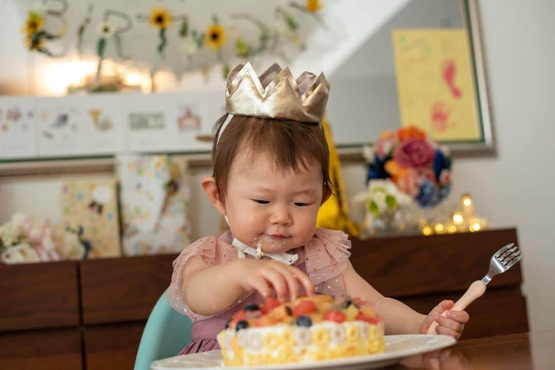 巴田みず希さんのインスタグラム写真 - (巴田みず希Instagram)「一歳お誕生日会🎂 ・ パパシェフが、お家でケーキを焼いてくれたよ♡ ・ 初ケーキが美味しかったようで、ガツガツ食べてた😂 ・ 小晴くんもフルーツをパクパク食べました🐕✨ ・ 写真館で真顔しか撮れなかったからママ、必死で笑わせたよ！笑 ・ 向日葵ガーランドは、ミンネで購入。（麻のガーランドも一緒に） @azukichan.shop @minne_official ・ ギリギリになって、やっぱり欲しい！と思って購入を決めたんだけど、迅速な対応していただいてほんとに助かりました〜🙇‍♀️ ・ 一歳の手形と足形もスタンプして👣 ・ 金の数字はフライングタイガーで100円だったよ〜 @flyingtigerjp ・ 月齢カードはママの手作り♡ ・ 素敵なレディになってね♡姫♡ ・ ・ ・ #1歳 #12months #12ヶ月baby #女の子ママ #新米ママと繋がりたい #赤ちゃんのいる生活 #あかちゃんのいる暮らし #可愛い #cute #baby #女の子ベビー #youtuber #毎日バタバタだけど幸せな日々 #30代初ママ #育児  #赤ちゃんとチワワ #月齢フォト #2018_summer_baby部 #photooftheday #babywearing #ベビーファッション #お誕生日会 #1歳誕生日 #バースデー購入品 #minne #フルーツケーキ #marlmarlエプロン #gapbaby」8月16日 10時12分 - mizukitomoda