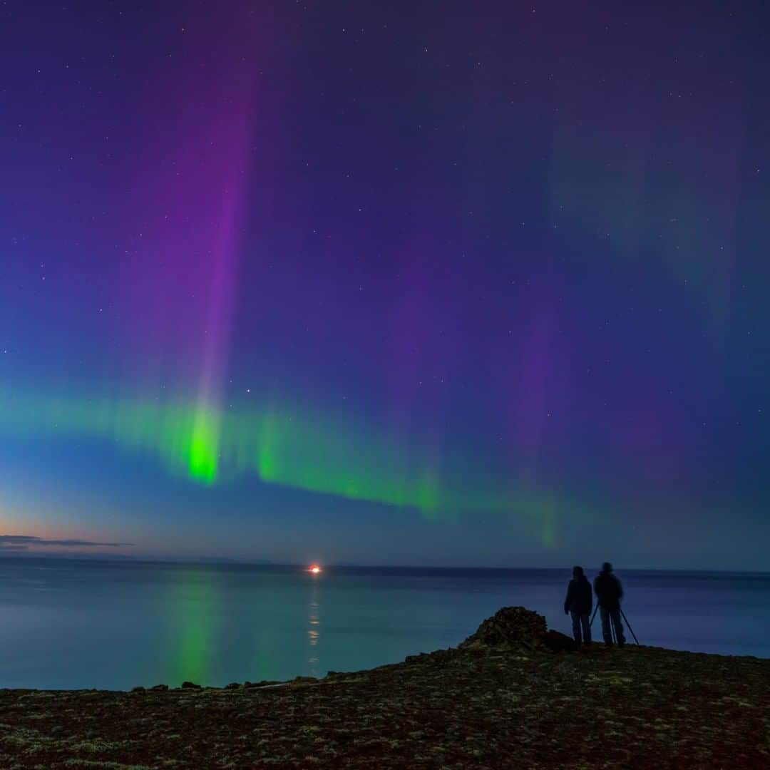 National Geographic Travelさんのインスタグラム写真 - (National Geographic TravelInstagram)「Photo by @BabakTafreshi | As fascinating as the aurora was, the excitement of this couple seeing the northern lights for the first time, bursting in colorful rays above the shore of the Atlantic Ocean in West Iceland, was better. People often ask me the where and when to see the lights. Once you are near polar latitudes in the right season there is no particularly favored place for aurora watching, anywhere with a clear sky, away from city lights and an open horizon works fine. Pick a moonless night to see fainter auroras, especially now that we are deep in the solar minimum and the activity is generally low. Sometimes you have to wait until midnight to see a better display. Anytime from September to March is fine when the sky is dark at latitudes of above 60 degrees. Check reliable sources like spaceweather.com for aurora activity and follow me @babaktafreshi for more. #twanight #aurora #northernlights #astrophotography #stargazing」8月18日 1時04分 - natgeotravel