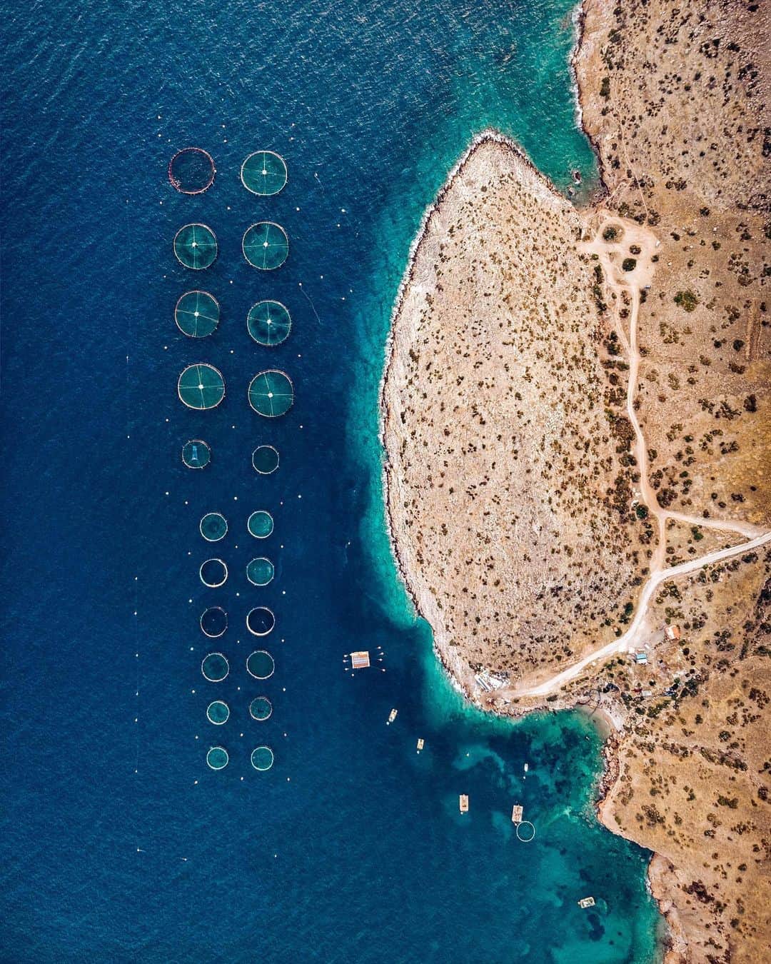 Daily Overviewさんのインスタグラム写真 - (Daily OverviewInstagram)「A fish farming operation is seen here in the Saronic Gulf, just offshore Greece’s Attica Peninsula. Fish farming — or pisciculture — involves raising fish in tanks or enclosures, usually for food. In 2015, Greece had at least 300 of these farms and raised more than 242 million pounds (109 million kg) of fish and mussels. /// Photo by @zizanius」8月19日 5時52分 - dailyoverview