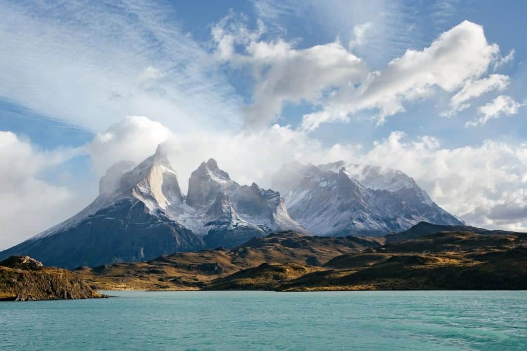 National Geographic Travelさんのインスタグラム写真 - (National Geographic TravelInstagram)「Photo by @michaelgeorge | Torres del Paine is the rare park where humans are the outsiders in a vast, legitimate wilderness. Though it occupies 930 square miles, the park receives only 2,000 visitors per day in peak season. Here we travel over “Lago Pehoé,” translated as “Hidden Lake.” The color is caused by glacial “flour” or rock dust suspended in the water. In the distance you can see Macizo Paine, a group of mountains that look like broken teeth. #torresdelpaine #patagonia #chile」8月19日 16時02分 - natgeotravel