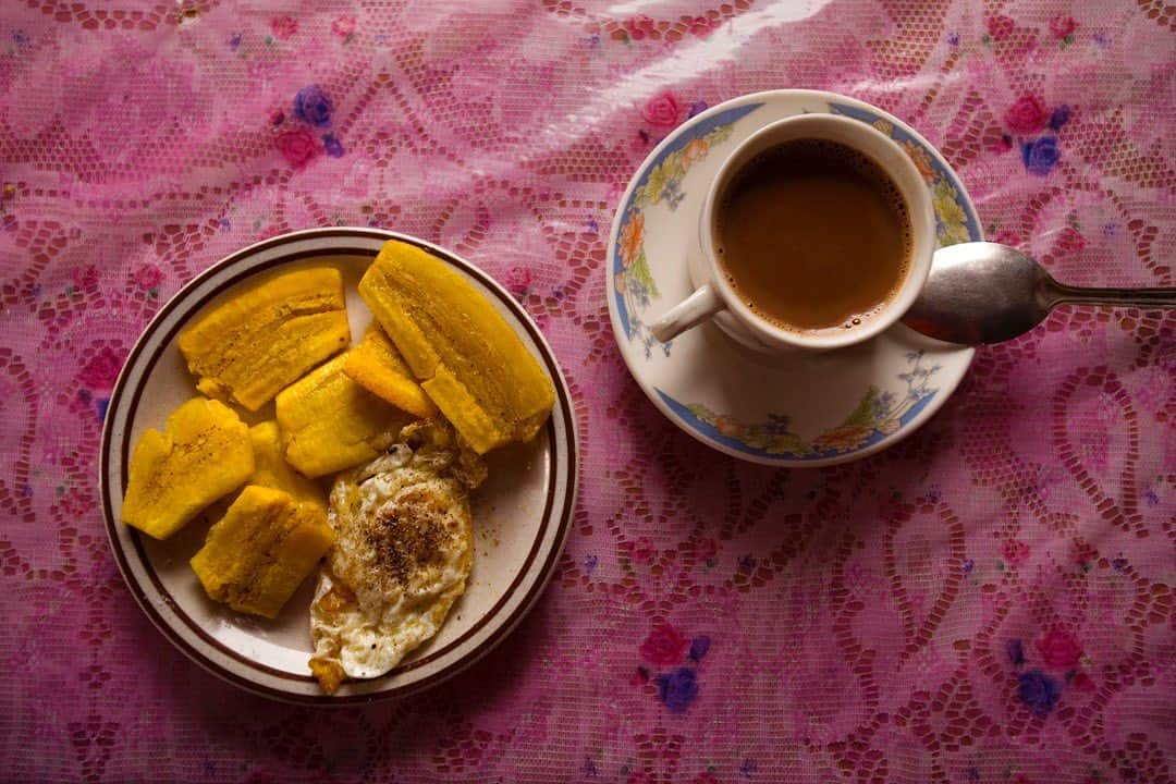 thephotosocietyさんのインスタグラム写真 - (thephotosocietyInstagram)「Photo by Ivan Kashinsky @ivankphoto | A breakfast of patacones (fried plantains), a fried egg, and hot chocolate rest on a pink tablecloth in the house of Ramón and Elisa Aguayo on the Hacienda Mariana in Los Ríos, Ecuador. This photo was part of book project in which Karla Gachet (@kchete77) and I traveled from the Equator to the southern tip of South America. @runa_photos, @panospictures, #runaflirts」8月20日 9時35分 - thephotosociety