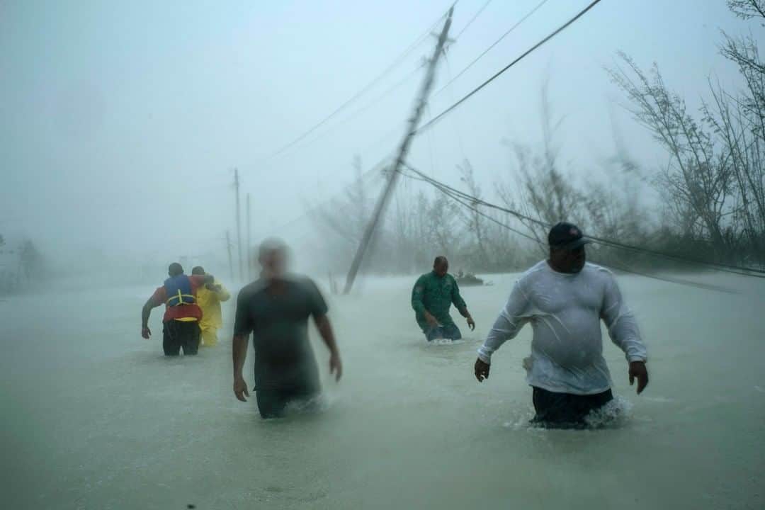 TIME Magazineさんのインスタグラム写真 - (TIME MagazineInstagram)「Volunteers walk through wind and rain on a flooded road in Freeport, Grand Bahama, Bahamas, after rescuing several families that arrived in the area on small boats on Sept. 3. #HurricaneDorian hit the #Bahamas on Sunday as one of the most powerful Atlantic hurricanes on record. The storm's punishing winds and floodwaters devastated thousands of homes, crippled hospitals and trapped people in attics. At least seven deaths were reported in the Bahamas, with the full scope of the disaster still unknown. Prime Minister Hubert Minnis has described the hurricane as a “historic tragedy” for the northern Bahamas. Photograph by Ramon Espinosa (@aprespinosa)—@apnews」9月5日 2時36分 - time