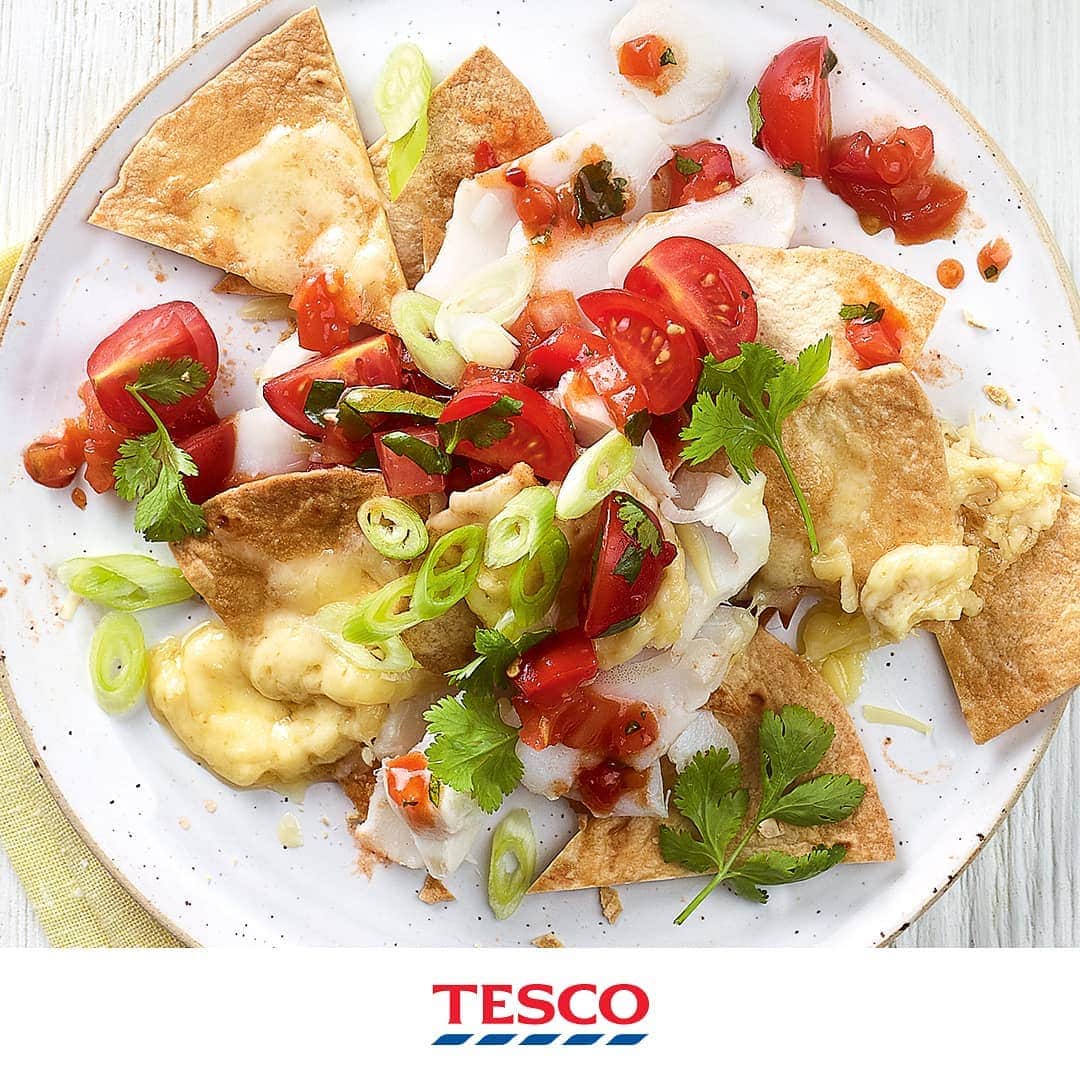Tesco Food Officialさんのインスタグラム写真 - (Tesco Food OfficialInstagram)「What do you call cheese that isn’t yours? Nacho cheese! Keep the whole family going strong through the school holidays with a big tray of thrifty, healthy, super-tasty fish nachos. The kids will love them almost as much as the grown ups!  Ingredients 4 plain tortilla wraps 2 frozen white fish fillets (about 175g) 15g butter 125g fresh salsa 50g 50% reduced-fat mature cheese, grated 100g Nightingale Farms cherry tomatoes, quartered 10g fresh coriander, most chopped, a few leaves reserved to garnish 2 spring onions, sliced  Method Preheat the oven to gas 6, 200°C, fan 180°C. Cut each tortilla into 8 triangles and spread out over 2 baking trays. Bake for 5-6 mins until crisp and just starting to turn golden. Meanwhile, dot the fish with butter. Place on a microwavable plate, cover loosely and cook on full power for 5 mins*, turning halfway. Transfer to a clean plate, pat dry with kitchen paper, then flake and gently toss with 75g salsa. Put the tortillas in an ovenproof dish, top with the fish and scatter over the cheese. Bake for 5-7 mins until the cheese starts to melt. Meanwhile, mix the cherry tomatoes and chopped coriander into the remaining salsa. Serve a few spoonfuls on top of the nachos (serve the remainder on the side). Scatter over the spring onions and reserved coriander leaves.」8月21日 21時02分 - tescofood