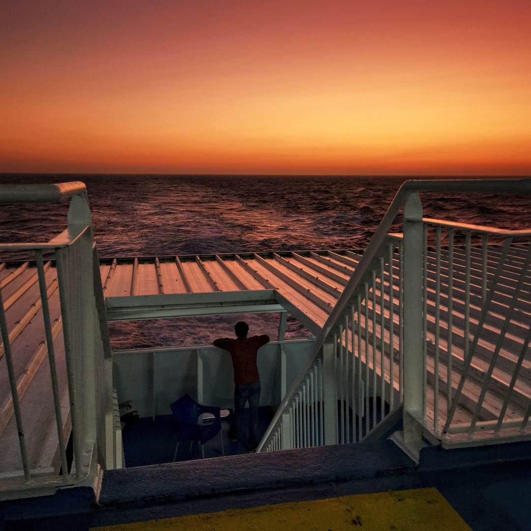 AFP通信さんのインスタグラム写真 - (AFP通信Instagram)「AFP Photo 📷 @aris.messinis - This photograph taken in August, 2019, shows a man standing on the deck of a ferry enroute to the Greek Island of Leros. #sunset」8月24日 20時10分 - afpphoto