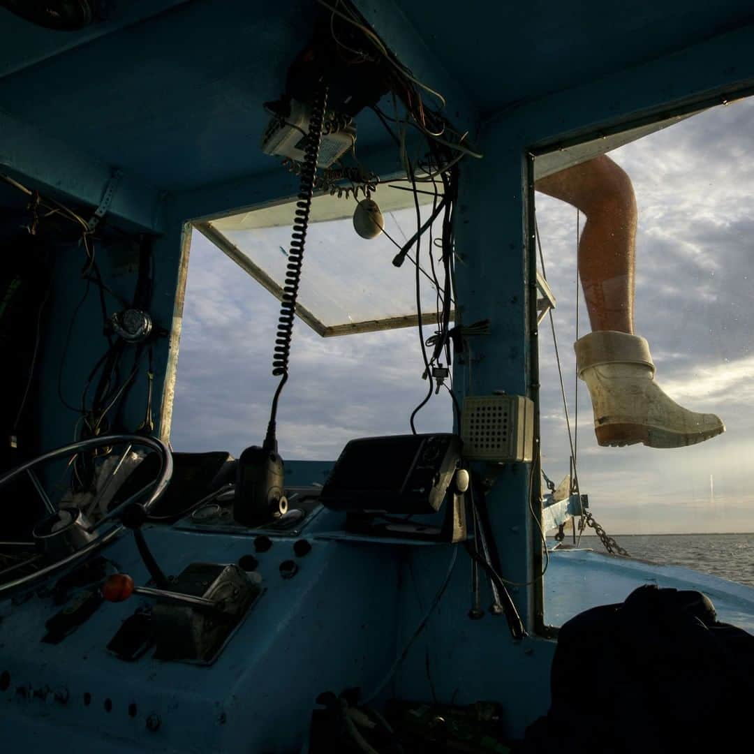 TIME Magazineさんのインスタグラム写真 - (TIME MagazineInstagram)「Caleb Hanson, grandson of longtime shrimper Acy Cooper, sits atop their shrimp trawler as they take off for a 12-hour-plus overnight shift off the coast of Plaquemines Parish, La., on Aug. 26. Four generations of the Cooper family have been fishermen. With parts of the Mississippi River experiencing historically high water levels earlier this year due to severe flooding in the Midwest, the opening of the Bonnet Carré Spillway (west of #NewOrleans) has flooded the salt water marshes with fresh water. That, in turn, has driven shrimp, crabs and fish from marshes and bays further out to sea in search of saltier water. In June, #Louisiana Gov. John Bel Edwards announced he had requested a federal fisheries disaster declaration, noting the resulting troubles for those who work in the coastal seafood industry. Photograph by @drewangerer—@gettyimages」8月28日 9時34分 - time