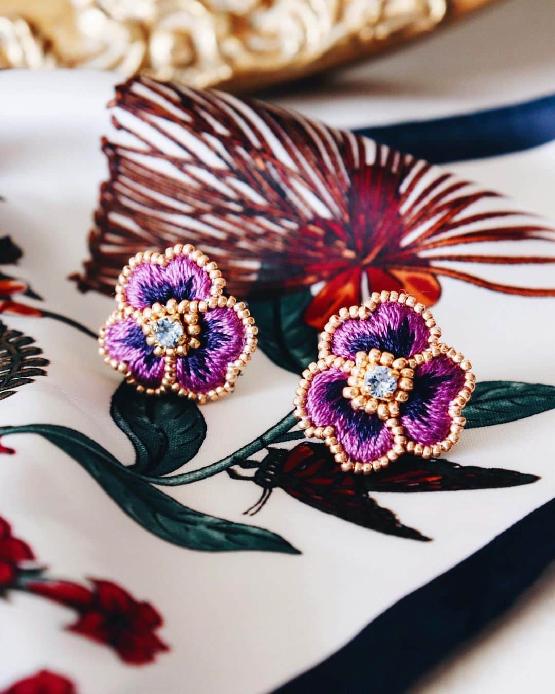 handmade shopのインスタグラム：「一粒パンジー﻿ ﻿ ブルーのスワロに﻿ 濃い紫色の刺繍糸を合わせました﻿ ﻿ 上品さの中に爽やかさもプラスされた﻿ パンジーです﻿ 9月のonline shopで販売します🌜﻿ ﻿ ﻿」