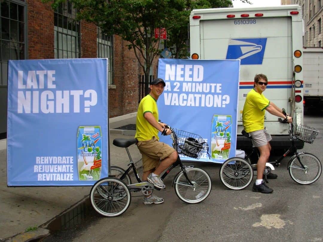 Vita Coco Coconut Waterのインスタグラム：「#throwbackthursday to our founders, Mike and Ira, getting our ads out there back in the day.  Vita Coco doesn't go out of style, the bright yellow t-shirts on the other hand....」