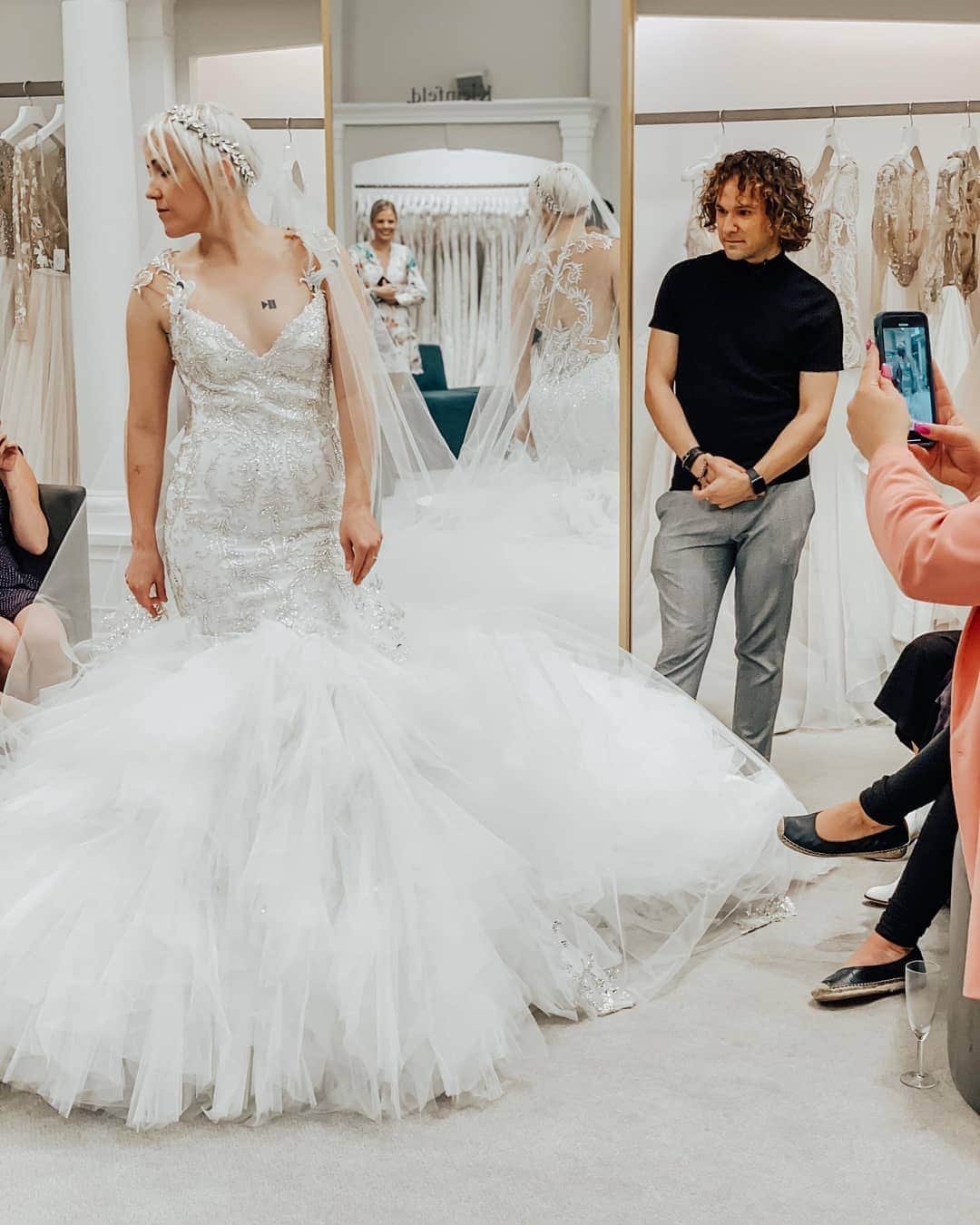 ハナー・ハートのインスタグラム：「Gonna be real... this is not what I'm wearing... But how could I resist posting these gorgeous photos by bridal photographer @gracehelbig in a gorgeous dress picked out by @mametown ?? p.s. major shout-out to my @kleinfeldbridal consultant @jmcalvanah for being my guiding light!  Check out all the looks I tried on ---> LINK IN STORY! 👰  #engaged #engayged #wedding #weddingdress #lgbtwedding #queer #queerfashion #engagementring」